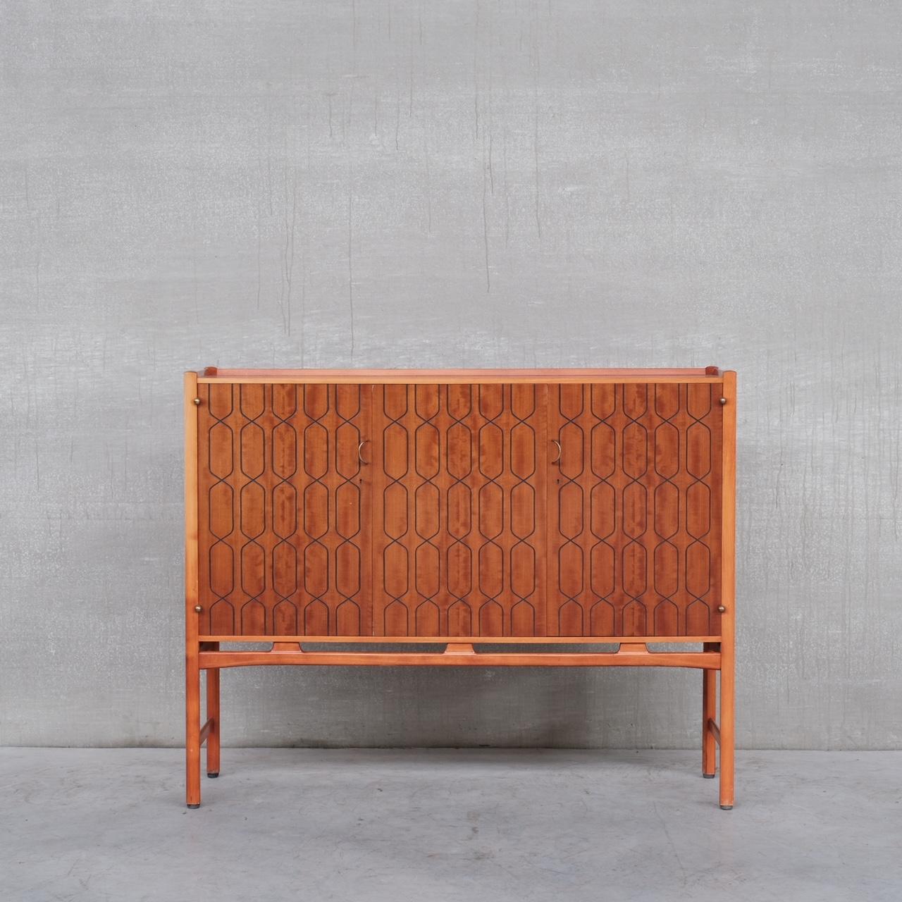 A scarce cabinet by David Rosen for Nordiska Kampaniet. 

Sweden, c1950s.

Teak and Beech with brass hardware.

Remains in good condition, some scuffs and wear commensurate with age. 

Location: Belgium Gallery. 

Dimensions: 46 D x 158 W