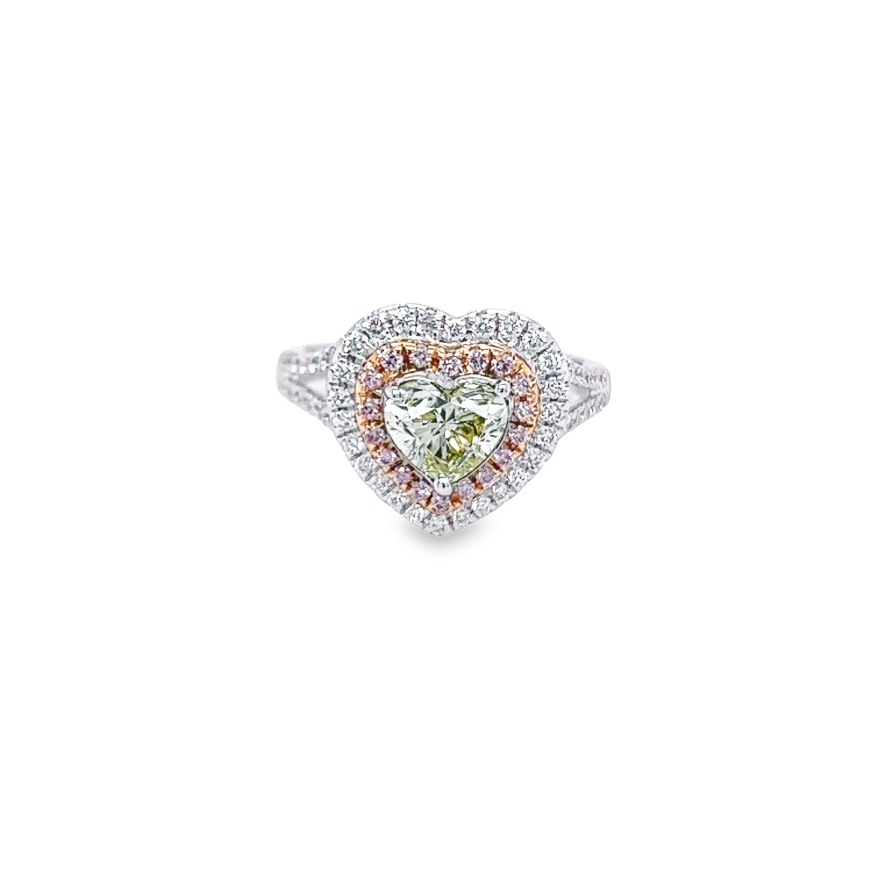 Rosenberg Diamonds & Co. 1.00 carat Heart Shape Fancy Green Yellow SI2 clarity is accompanied by a GIA certificate. This beautiful Heart is set in a handmade 18k white gold setting and completes the look with a beautiful double halo of .43 carat