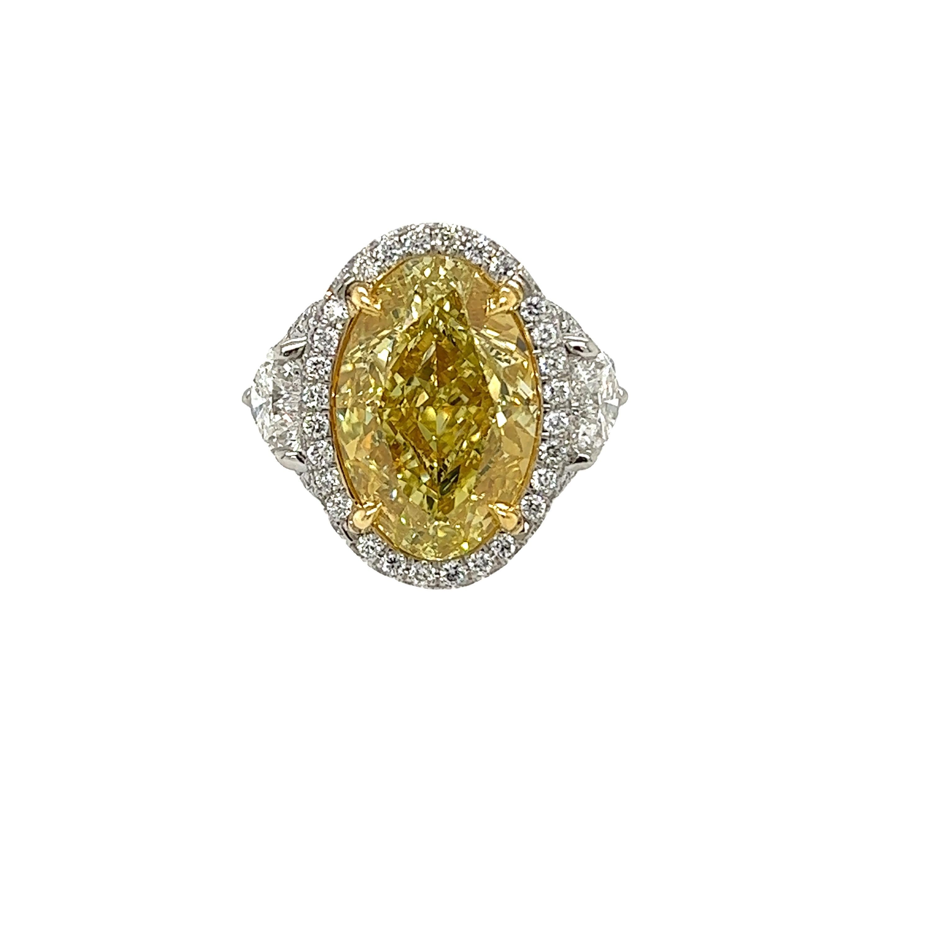 Rosenberg Diamonds & Co. 10.01 carat Oval Shape Fancy Yellow VS2 clarity is accompanied by a GIA certificate. This beautiful bright oval cut is set in a handmade platinum & 18k yellow gold setting with perfectly matched pair of heart shape side