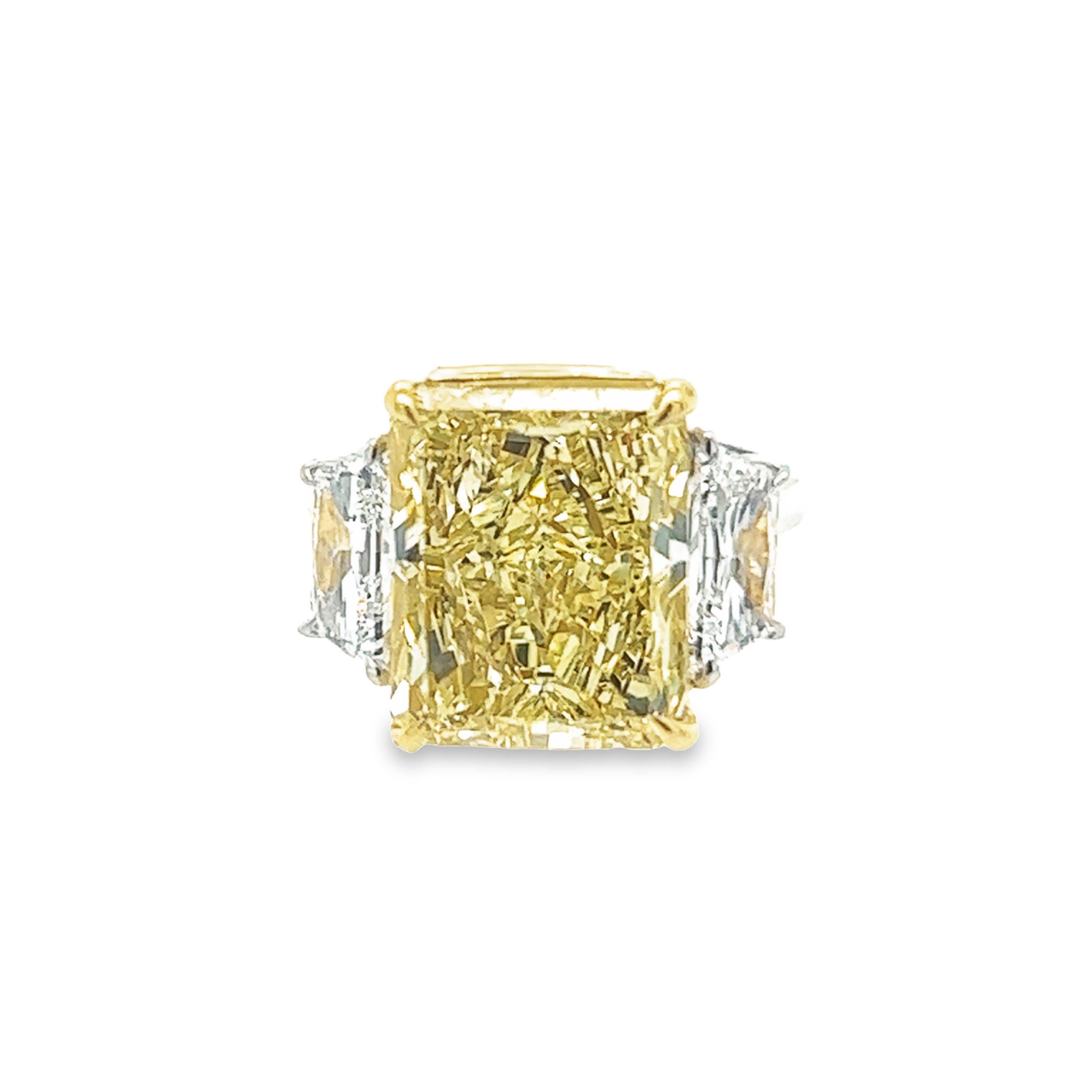 Rosenberg Diamonds & Co. 10.03 carat Radiant Cut Fancy Yellow VS2 clarity is accompanied by a GIA certificate. This extraordinary radiant cut is set in a handmade platinum & 18k yellow gold setting with perfectly matched pair of trapezoid side