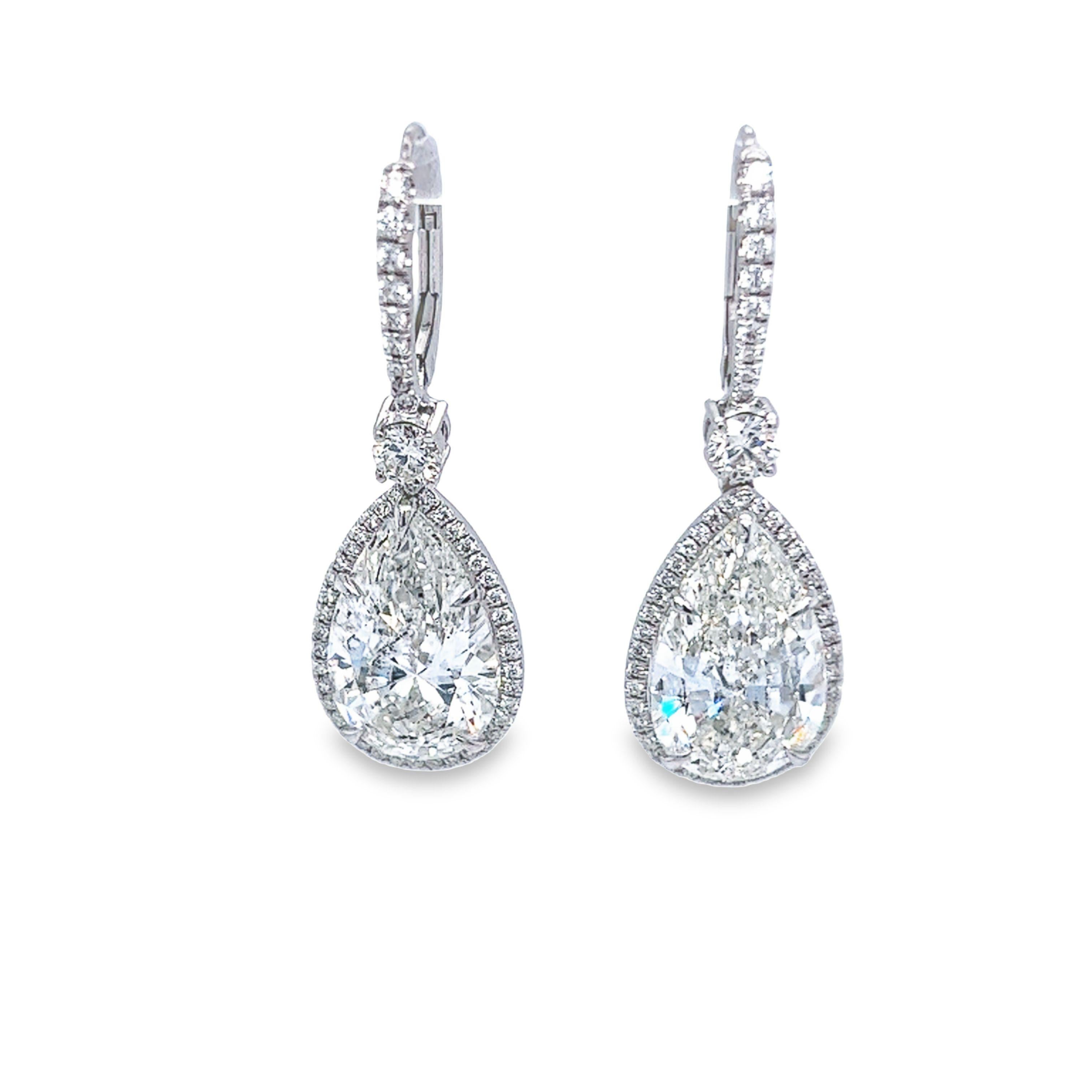 An impressive and rare 10.05 carat total weight matched pear shape with a color and clarity of J SI2 GIA certified. This exceptional SI2 is set in platinum surrounding the pear shapes is a very fine micro pave halo with a combined total carat weight
