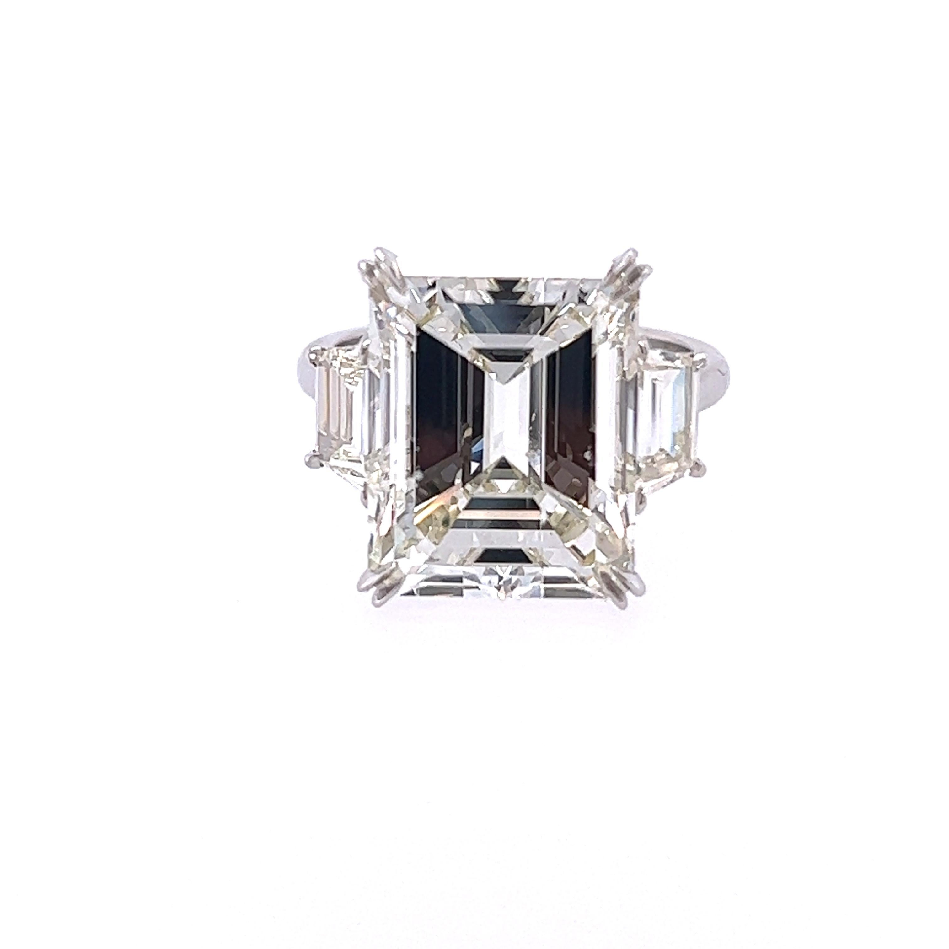 Rosenberg Diamonds & Co. 10.07 carat Emerald Cut L color SI2 clarity is accompanied by a GIA certificate. This spectacular Emerald is full of fire and it is set in a handmade platinum setting with perfectly matched pair of trapezoid side stones