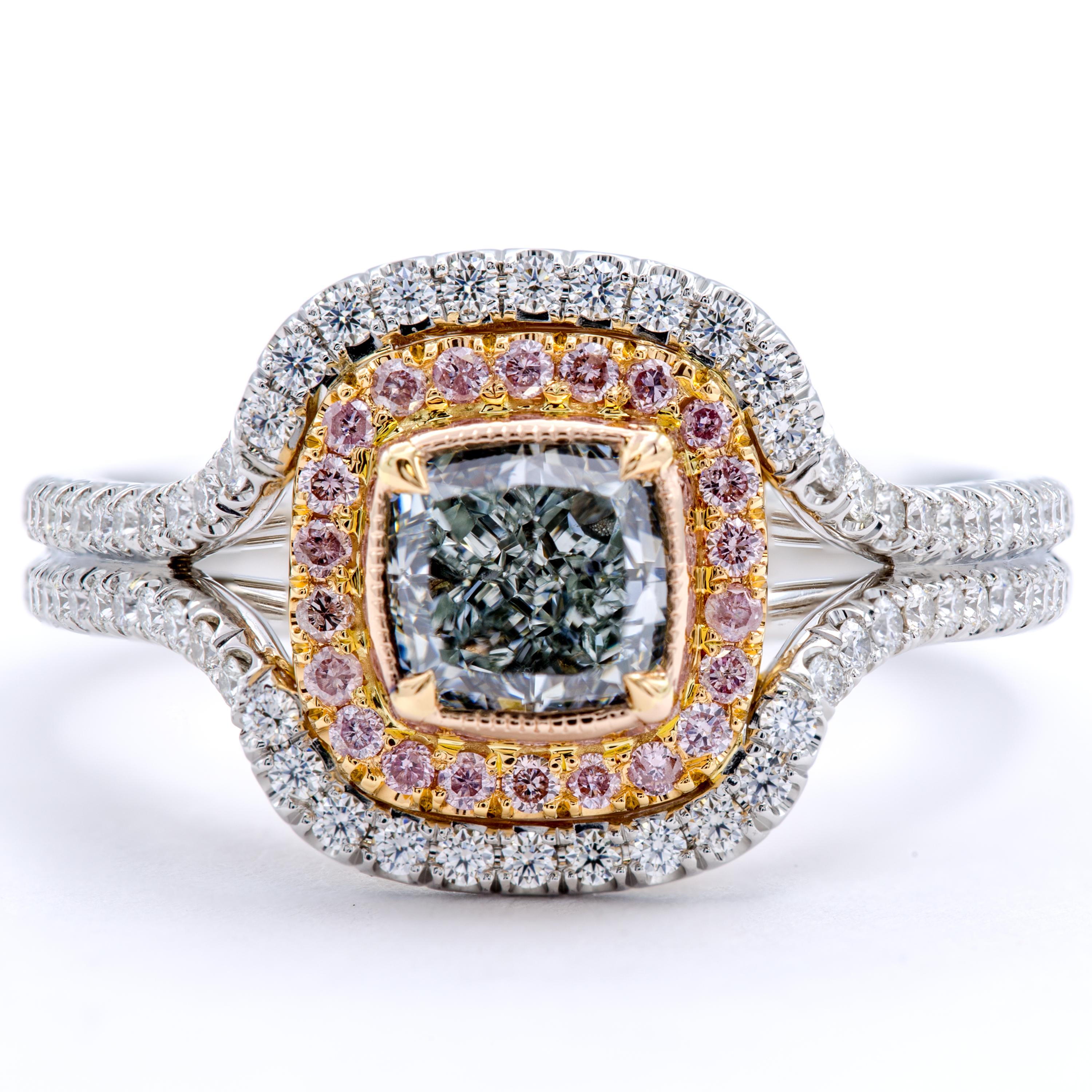 A perfectly petite and incredibly rare GIA certified fancy natural very light green rests within a halo of beautiful pink and white round brilliant pave diamonds. The band features smooth 18Kt white and rose gold formed into an accentuating band.