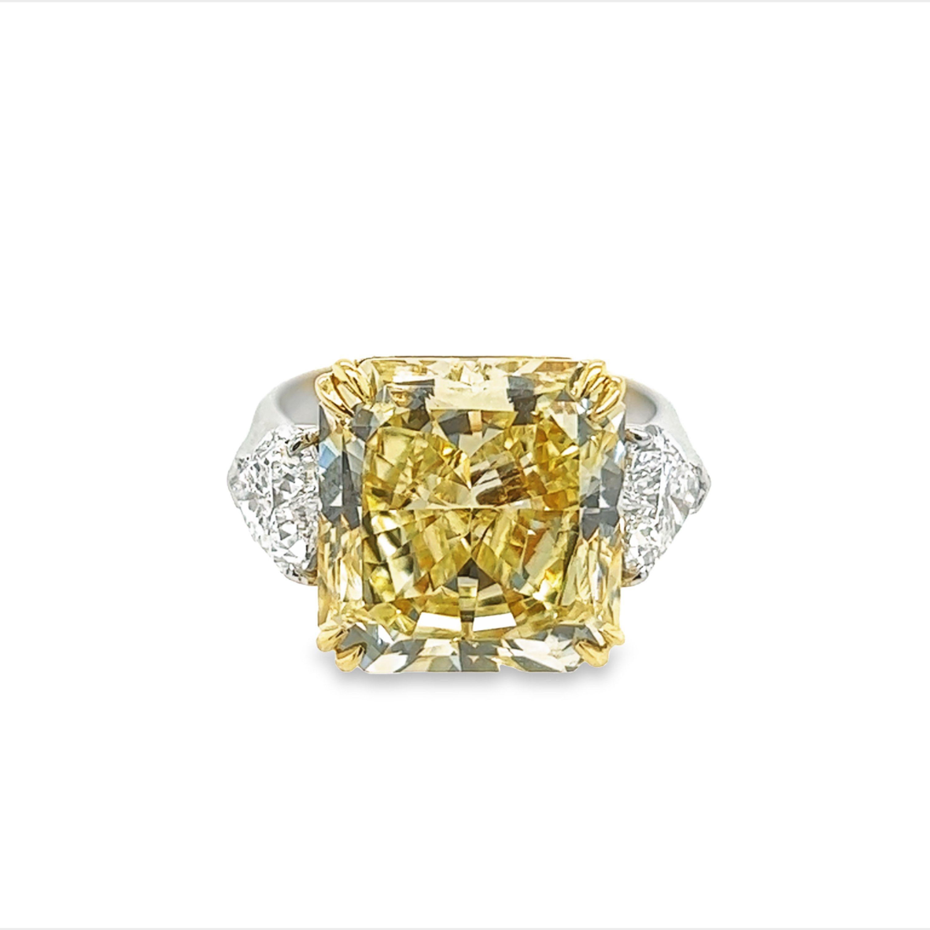 Rosenberg Diamonds & Co. 10.23 carat Radiant Cut Fancy Yellow VVS1 clarity is accompanied by a GIA certificate. This extraordinary radiant cut is set in a handmade platinum & 18k yellow gold setting with perfectly matched pair of heart shaped side