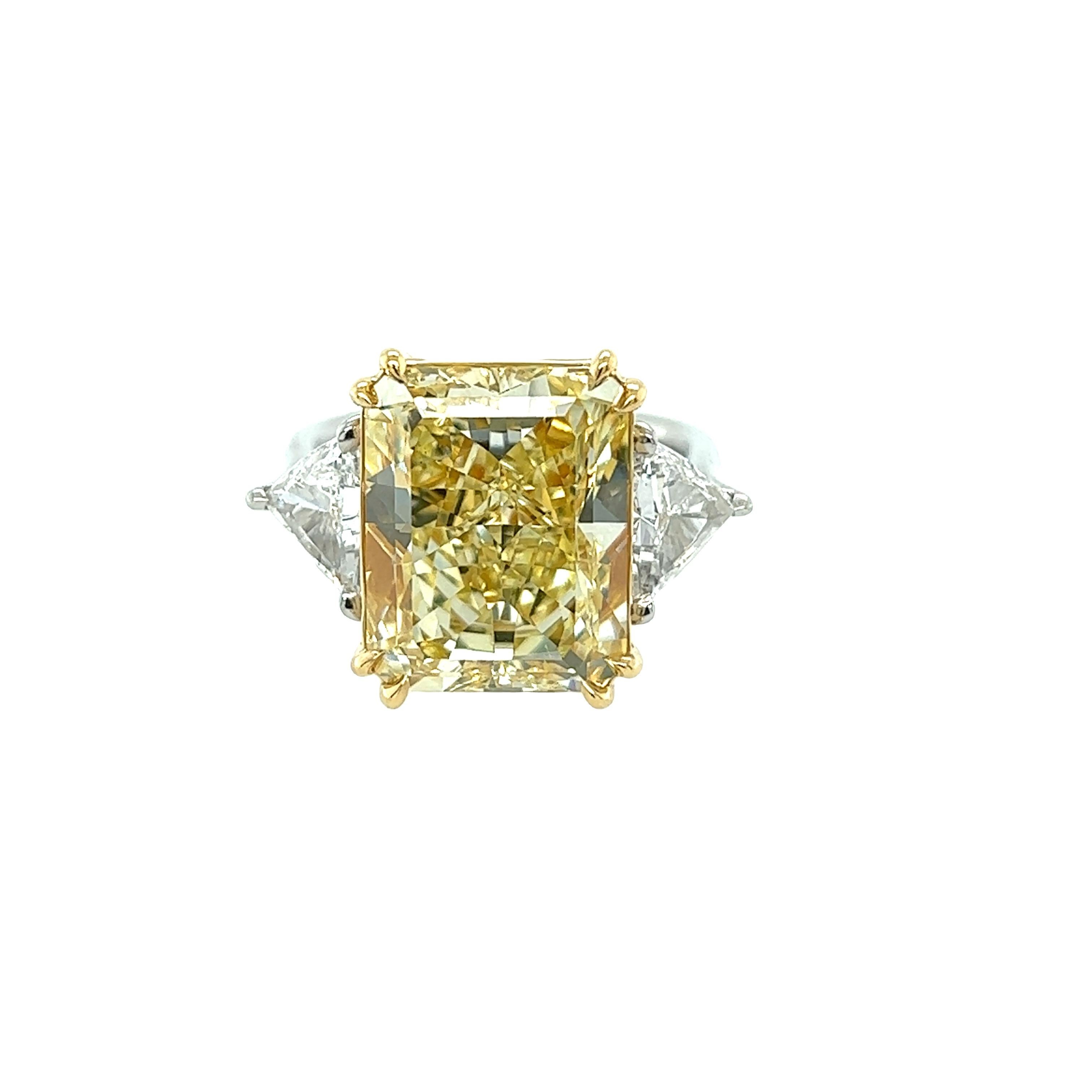 Rosenberg Diamonds & Co. 10.41 carat Radiant Cut Fancy Yellow VS1 clarity is accompanied by a GIA certificate. This extraordinary radiant cut is set in a handmade platinum & 18k yellow gold setting with perfectly matched pair of step cut trillion