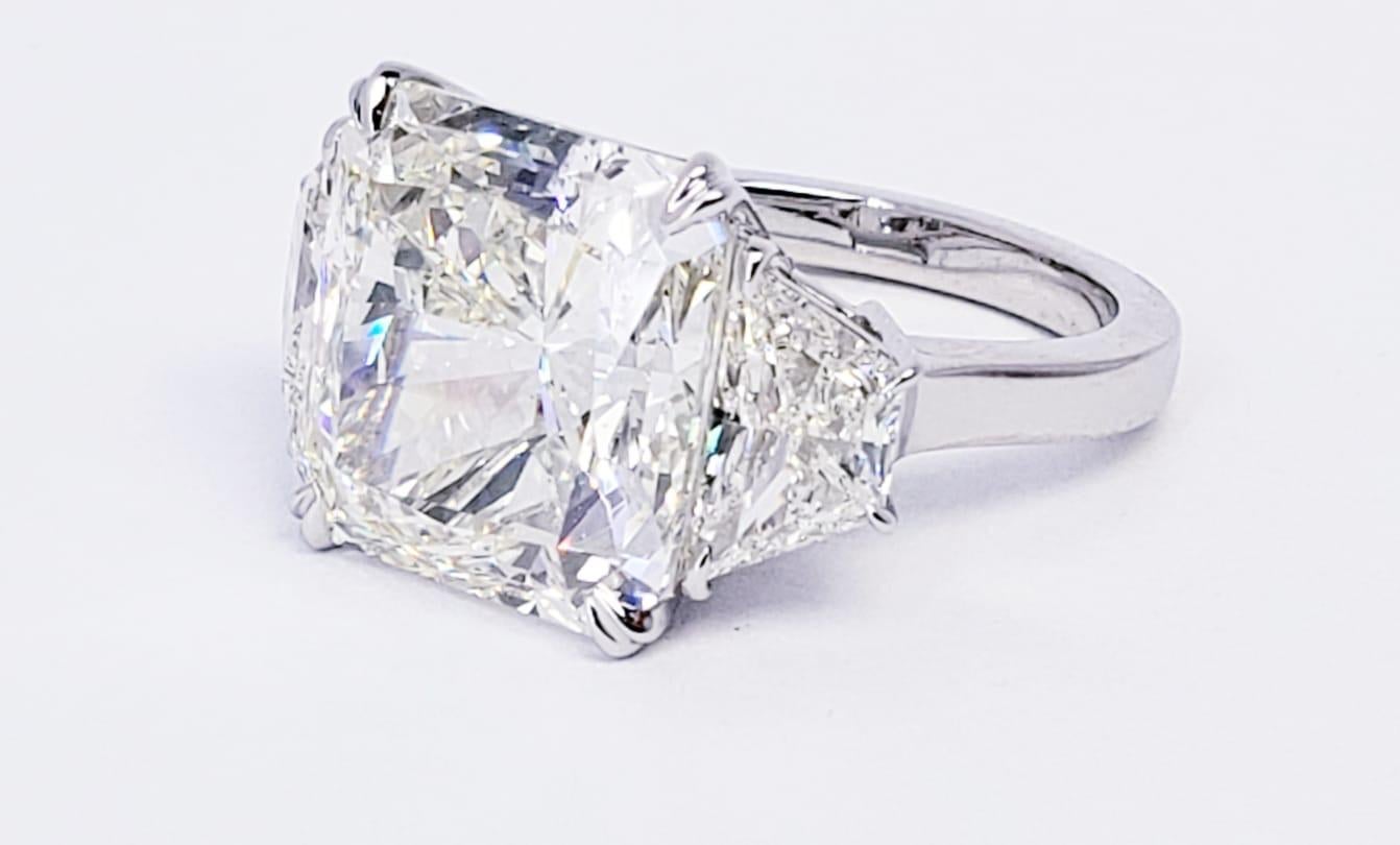 Rosenberg Diamonds & Co. 12.01 carat Radiant cut J color VS2 clarity is accompanied by a GIA certificate. This breathtaking three stone diamond ring is full of brilliance. It is set in a handmade platinum setting with perfectly matched pair of