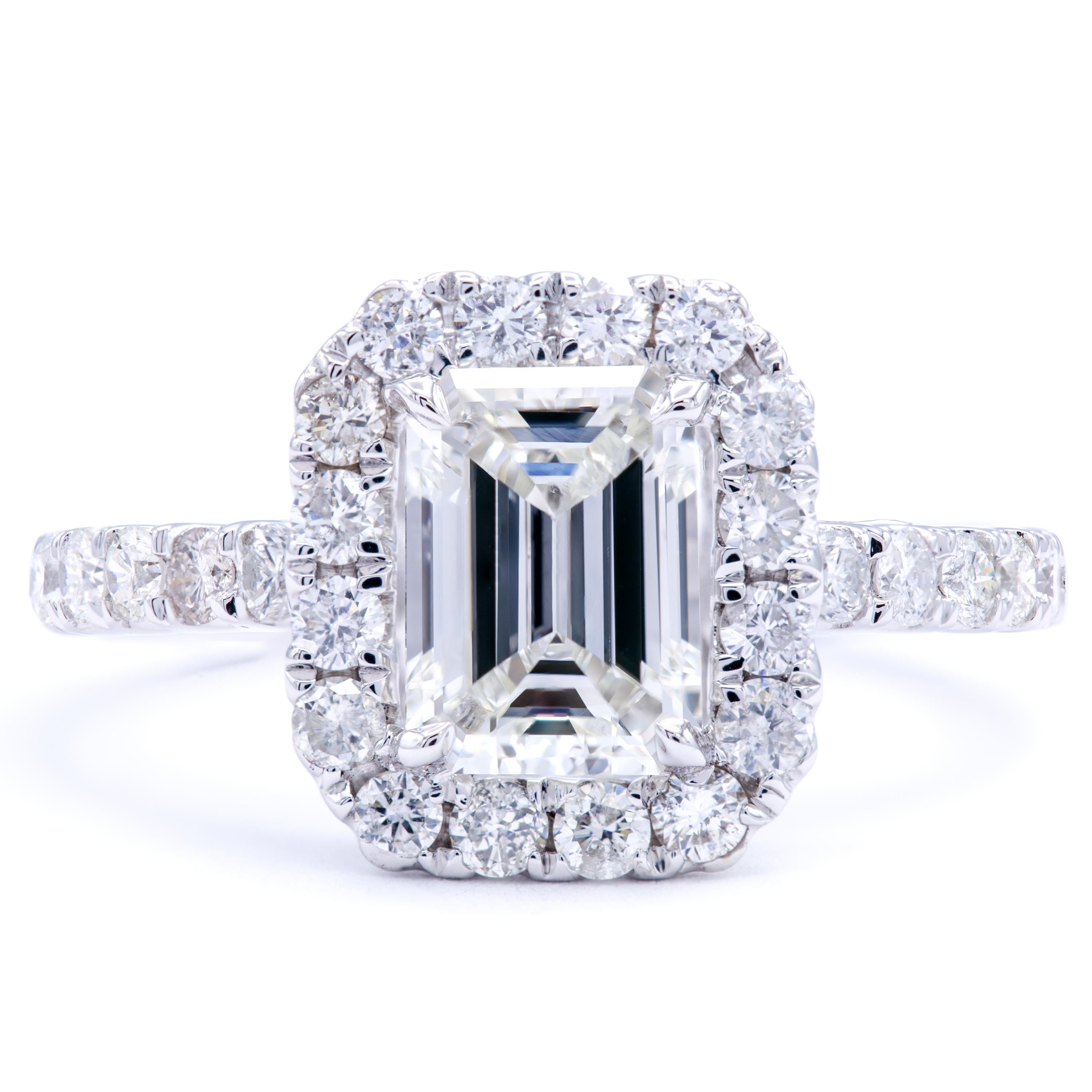 Bold in character and beautiful in rarity. This beautiful Rosenberg Diamonds & Co. engagement ring features a stunning GIA certified 1.21 carat emerald cut diamond embraced by round brilliant accents all across the band of 18Kt white gold. Designed