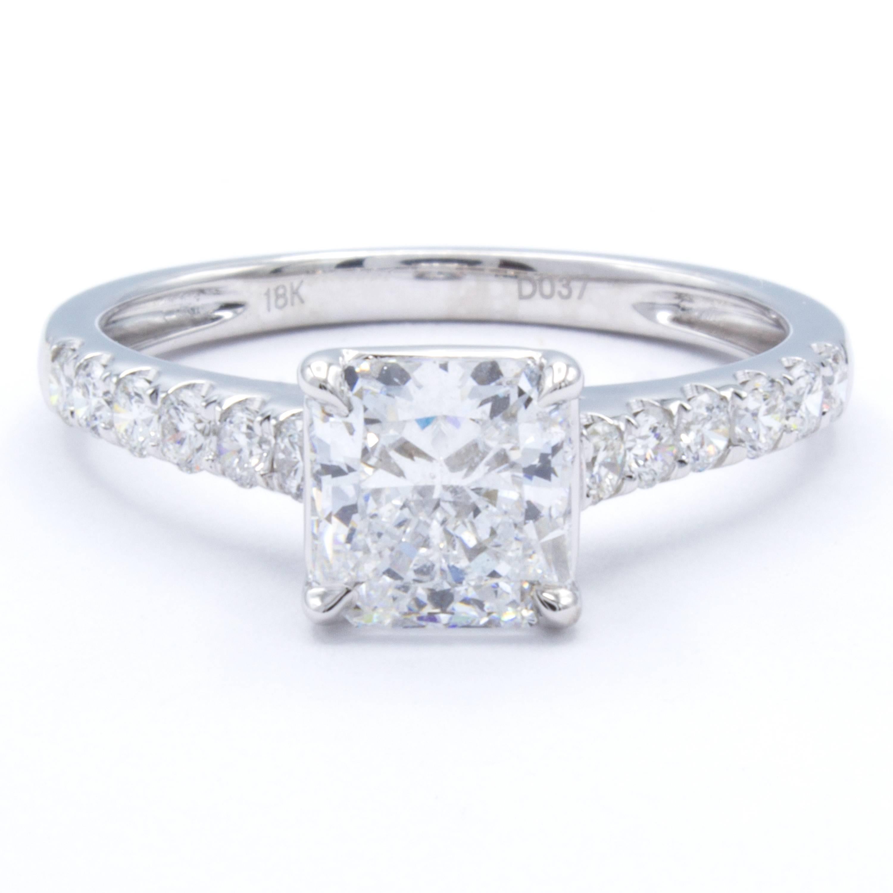 An elegant classic shows in this Rosenberg Diamonds & Co. engagement ring. A GIA certified 1.21 carat radiant cut diamond shines brilliantly within a cradle of round brilliant pave set diamonds on a band of bright 18Kt white gold. Designed by David