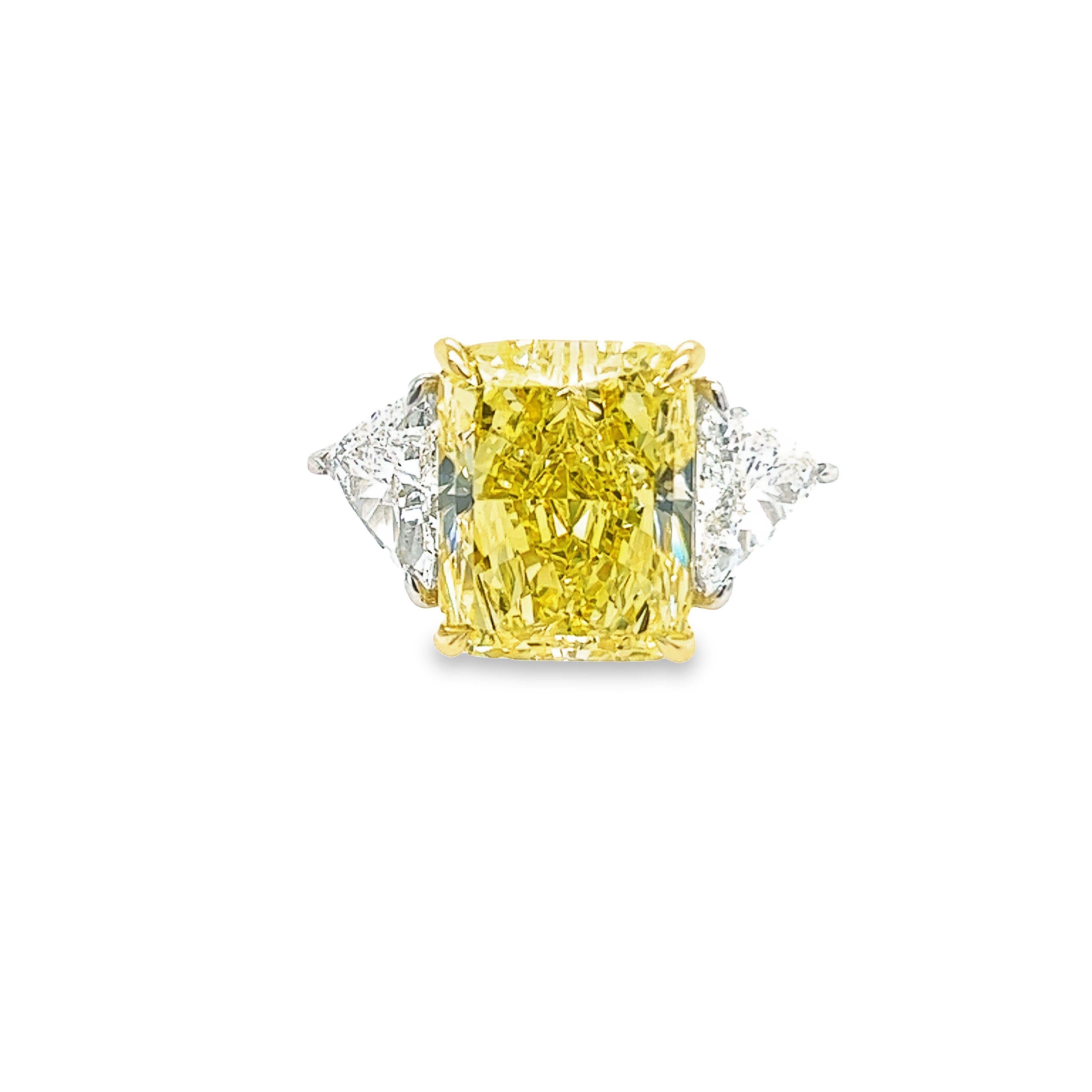 Rosenberg Diamonds & Co. 12.15 carat Radiant Cut Fancy Intense Yellow VS1 clarity is accompanied by a GIA certificate. This exquisite radiant cut is set in a handmade platinum & 18k yellow gold setting with perfectly matched pair of step cut