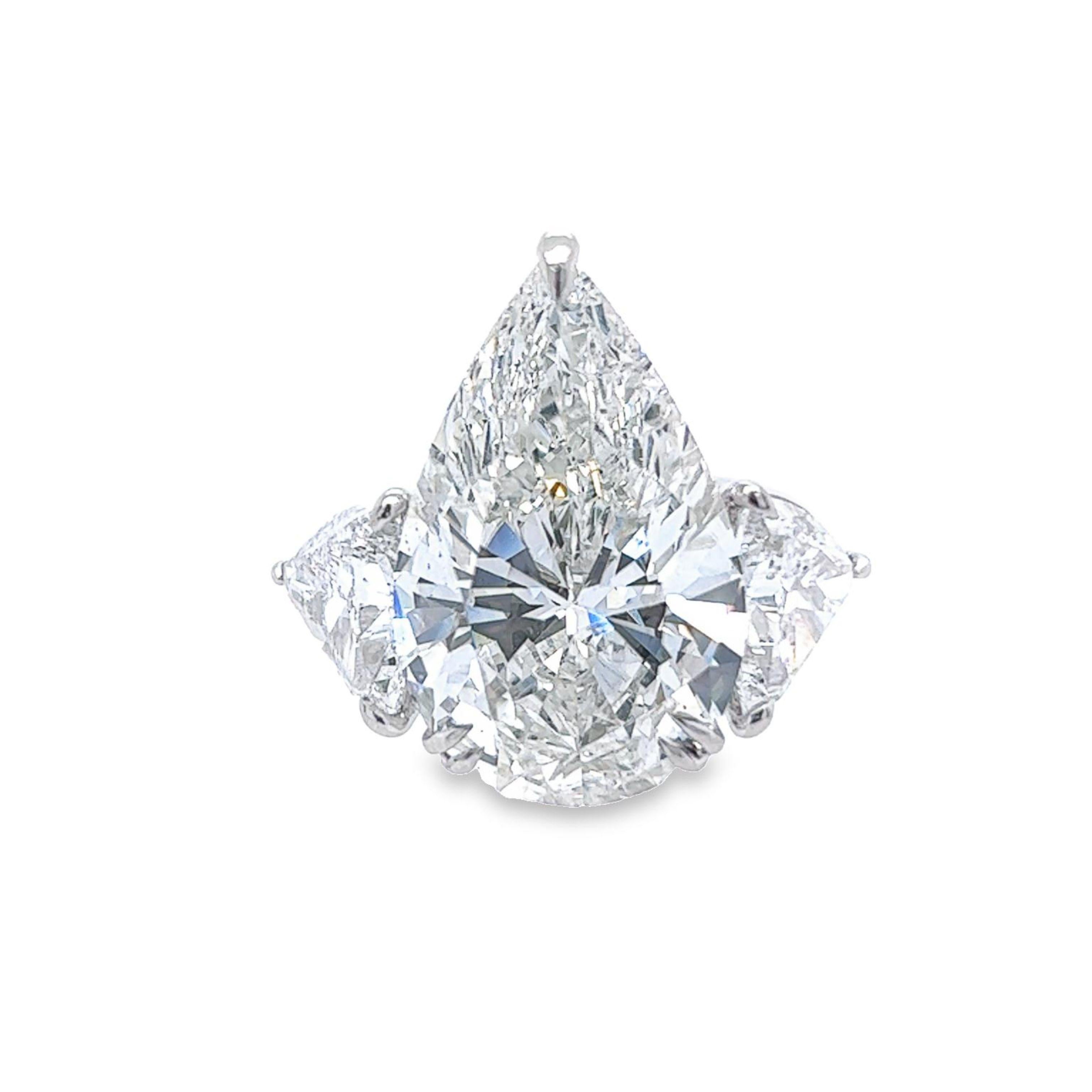 Rosenberg Diamonds & Co. 13.34 carat Pear shape H color SI2 clarity is accompanied by a GIA certificate. This exceptional  SI2 Pear shape is set in a handmade platinum setting with perfectly matched pair of trillion side stones flanking on both