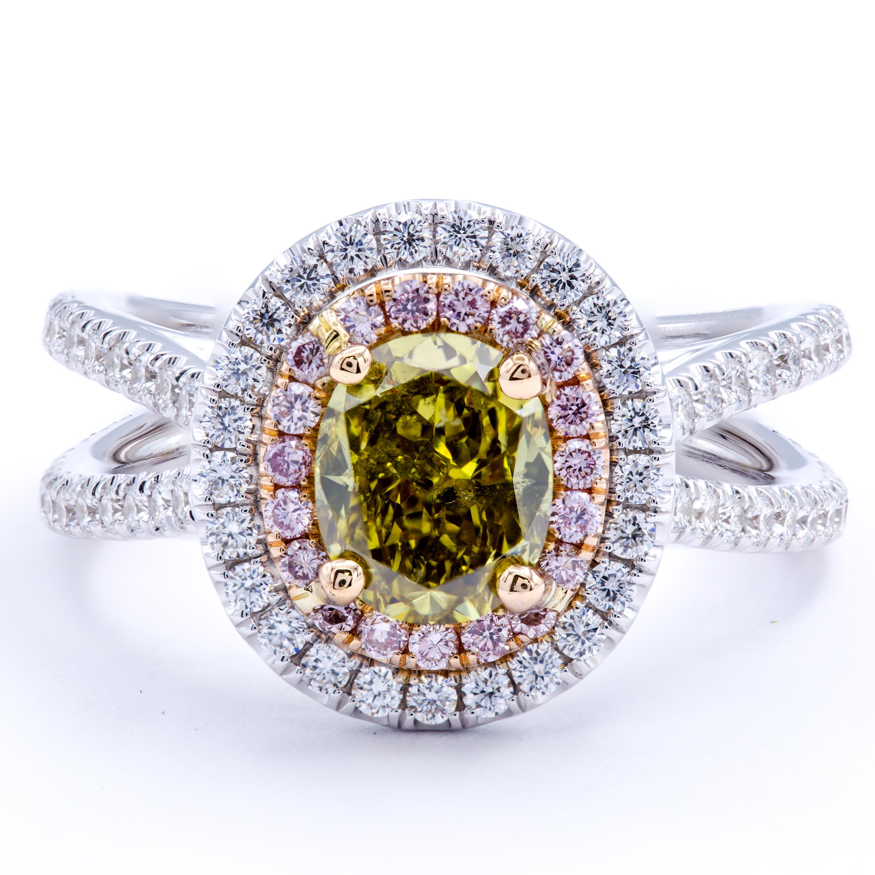 A rare GIA certified natural color diamond shows vibrant shades of fancy deep gray, green, and yellow throughout an Oval faceted shape. A platinum and multicolor 18Kt gold band carries a split shank design that is studded entirely with glittering