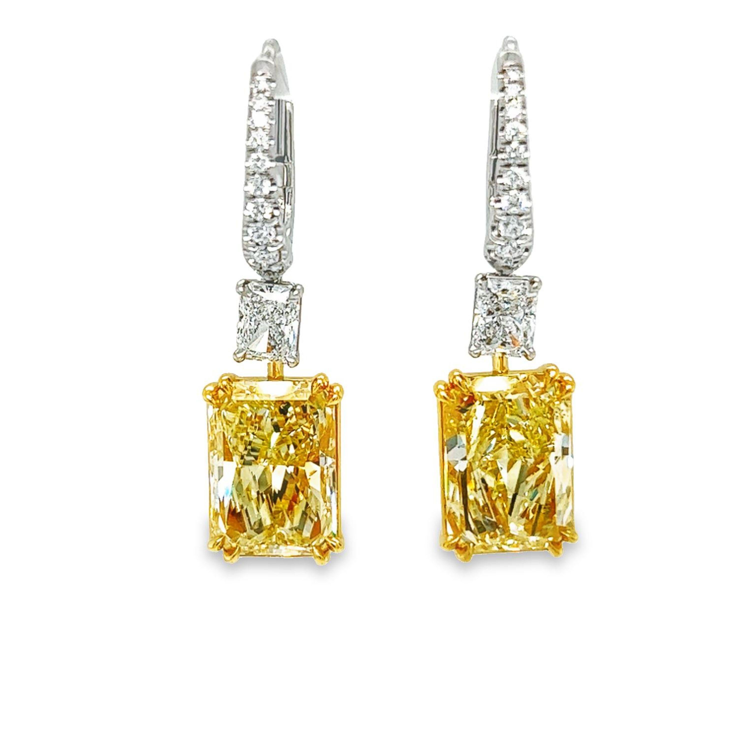 A beautifully matched 14.05 total weight Radiant Light Yellow SI1 - SI2 clarity diamond earrings are GIA Certified. These gorgeous light weight dangling earrings set in platinum & 18k yellow gold also features a matched pair of 1.41 carat total