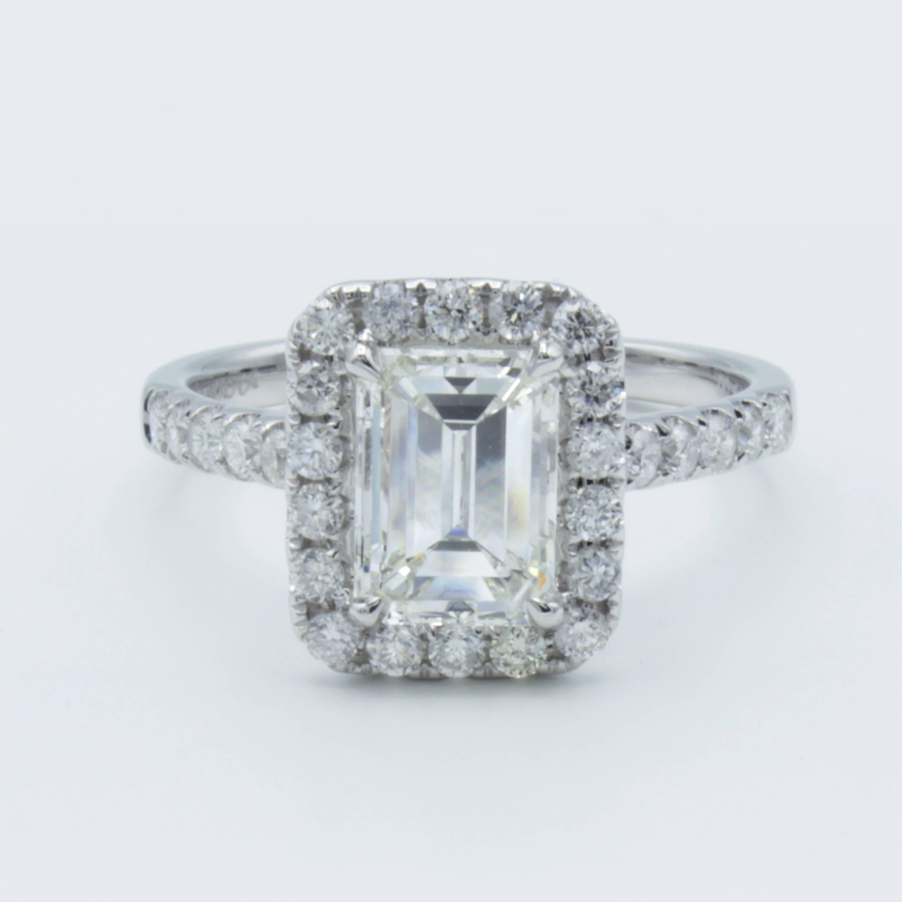 Bold in character and beautiful in rarity. This beautiful Rosenberg Diamonds & Co. engagement ring features a stunning GIA certified 1.51 carat emerald cut diamond embraced by round brilliant accents all across the band of 18Kt white gold. Designed