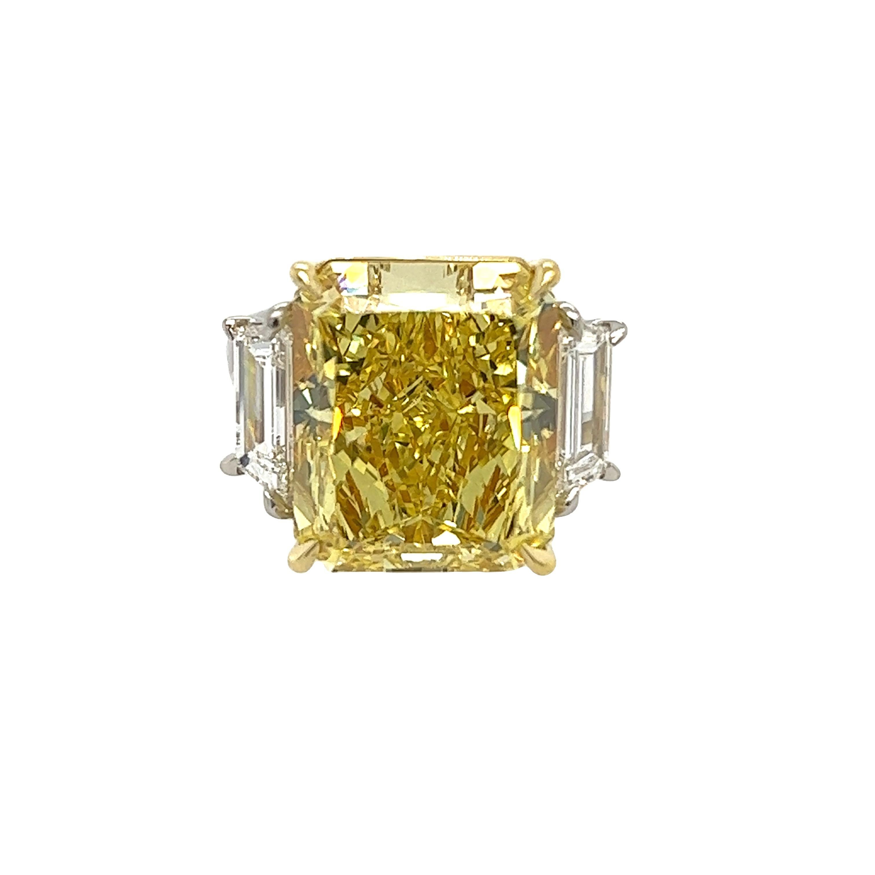 Rosenberg Diamonds & Co. 15.38 carat Radiant Cut Fancy Intense Yellow VS2 clarity is accompanied by a GIA certificate. This extraordinary radiant cut is set in a handmade platinum & 18k yellow gold setting with perfectly matched pair of step cut