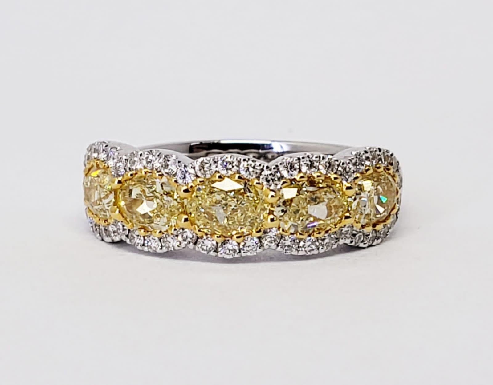 Rosenberg Diamonds & Co. 1.94 total carat weight Oval cut Fancy Intense Yellow VS2 clarity. This beautiful yellow diamond halfway wedding band is set in a handmade 18 karat white & yellow gold setting, with five carefully matched oval shape diamonds