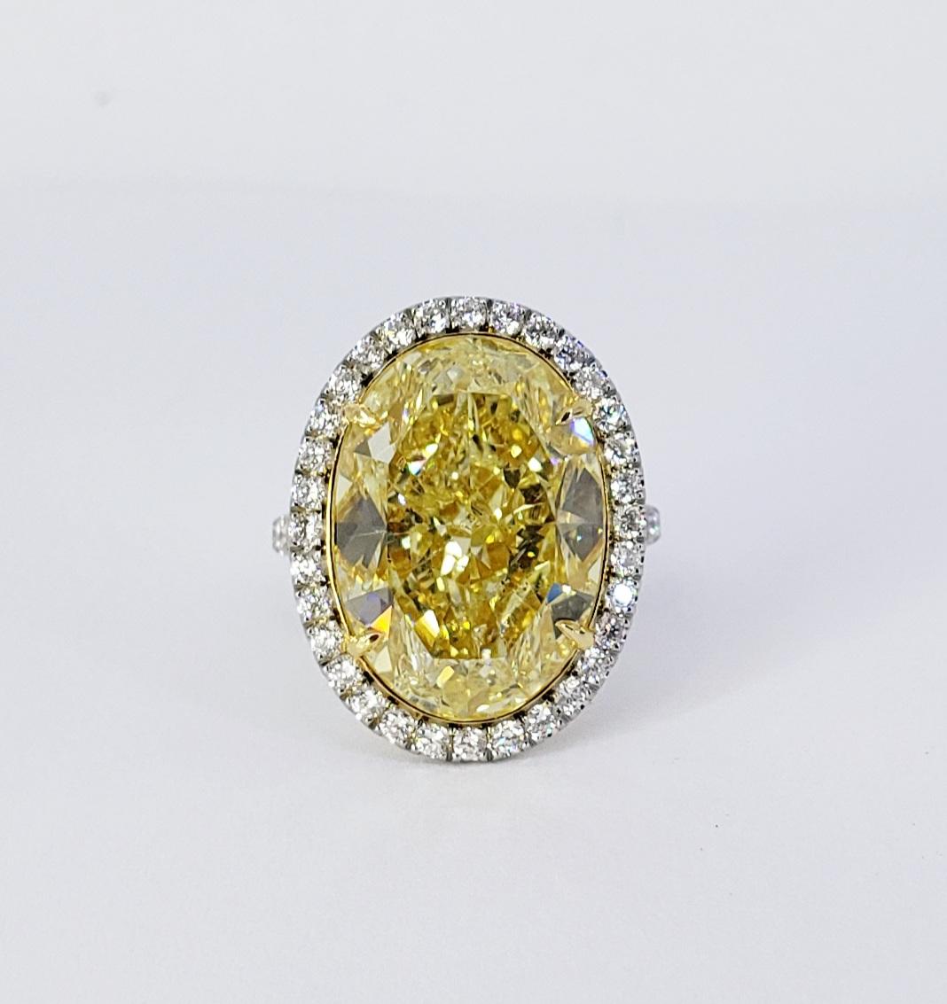 Rosenberg Diamonds & Co. 17.32 Oval shape Fancy Yellow SI2 Clarity is accompanied by a GIA certificate. This gorgeous Oval is full of life and is an exceptional SI2 that is set in a handmade platinum & 18 karat white setting. This ring continues its