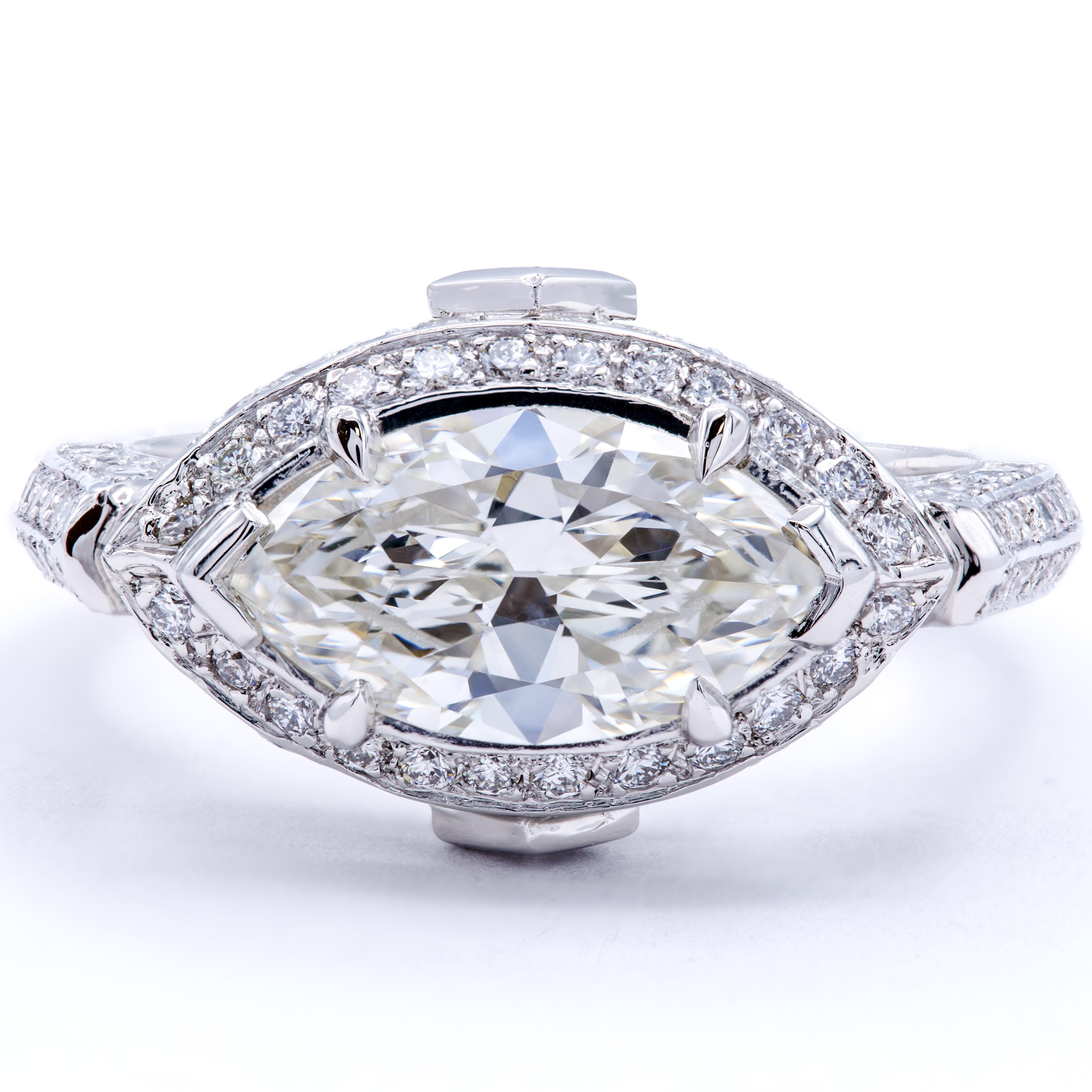 A wonderfully decadent marquise cut diamond rests at the center of this classic engagement ring design from Rosenberg Diamonds & Co. A GIA certified 1.83 carat marquise diamond scintillates with fiery reflections on a band of bright platinum. The