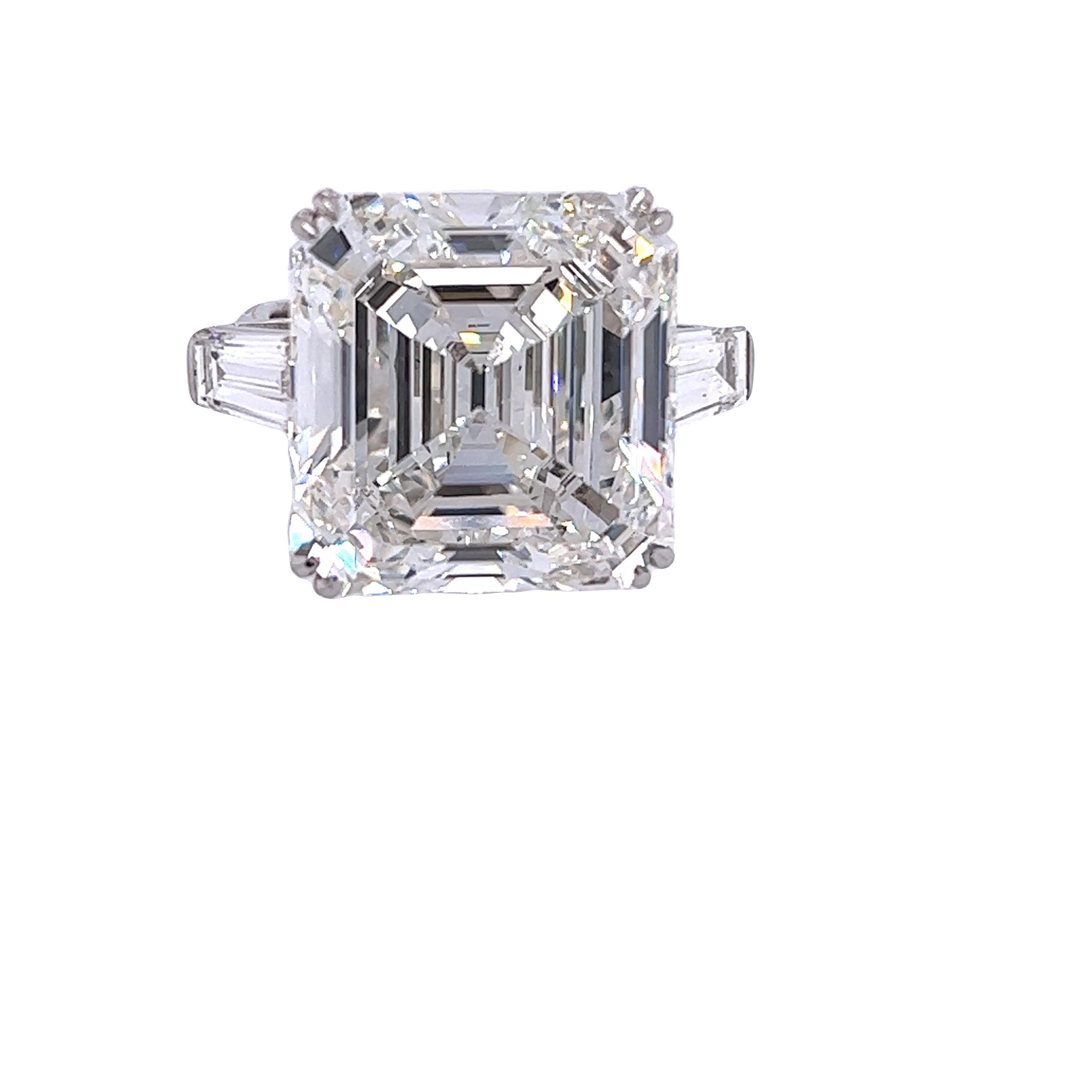 Rosenberg Diamonds & Co. 22.18 carat Asscher cut H color VS1 clarity is accompanied by a GIA certificate. This breathtaking Asscher is full of brilliance and it is set in a handmade platinum setting with perfectly matched pair of tapered baguettes