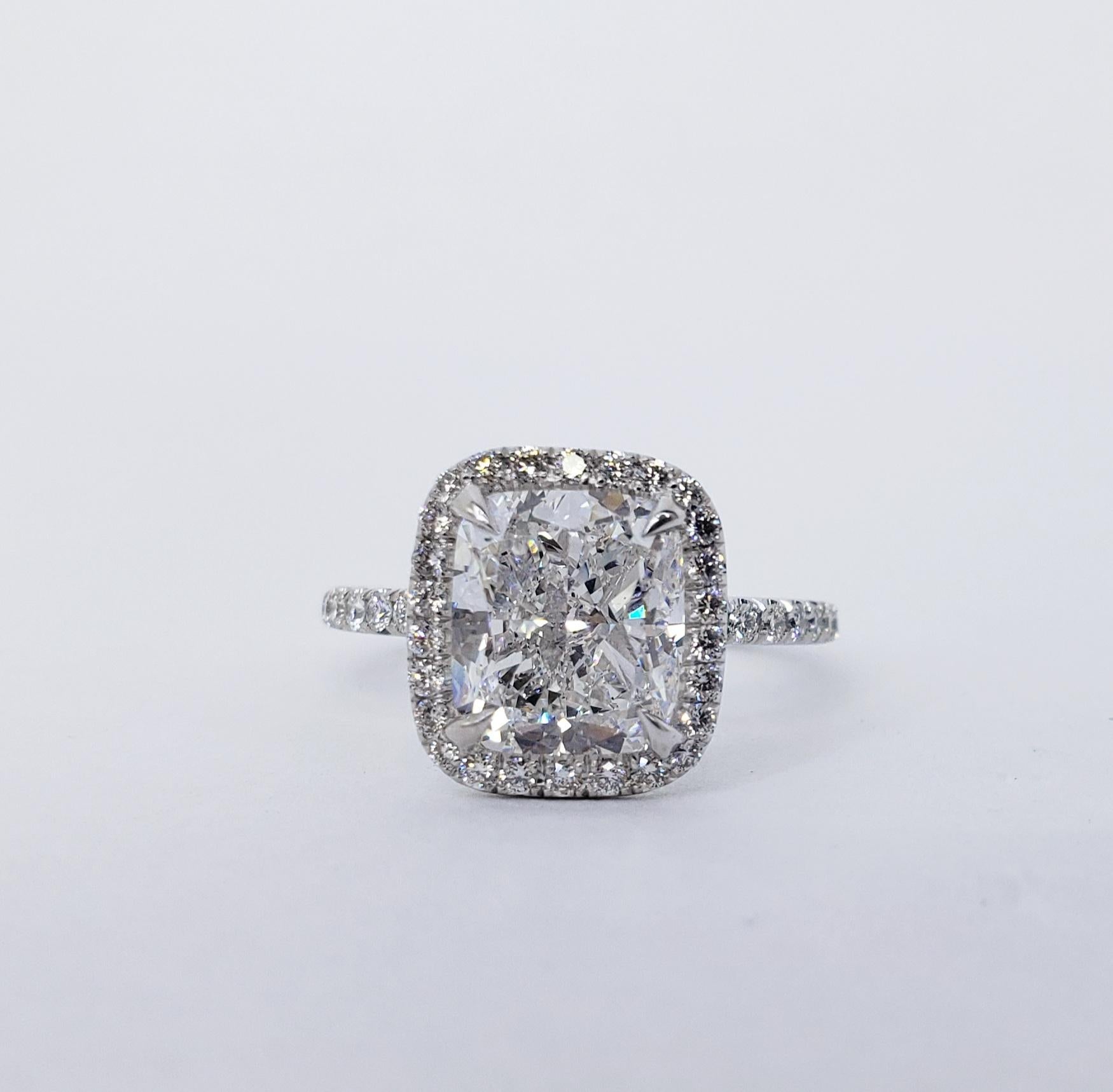 Rosenberg Diamonds & Co. 3.01 carat Cushion Cut D color VS2 clarity is accompanied by a GIA certificate. This spectacular cushion engagement ring is full of brilliance and it is set in a handmade platinum setting. This ring continues its elegance