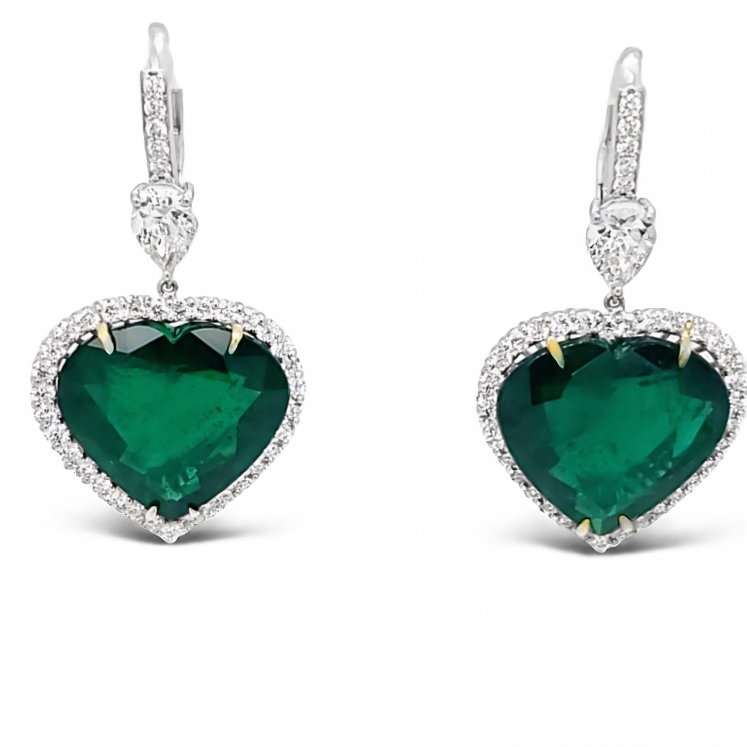 A beautifully matched green Zambian Emerald heart shape with superb luster and minimal gardening. These spectacular light weight dangling earrings also feature a matched pair of 1.42 carat total weight of collection pear shapes with an elegant micro