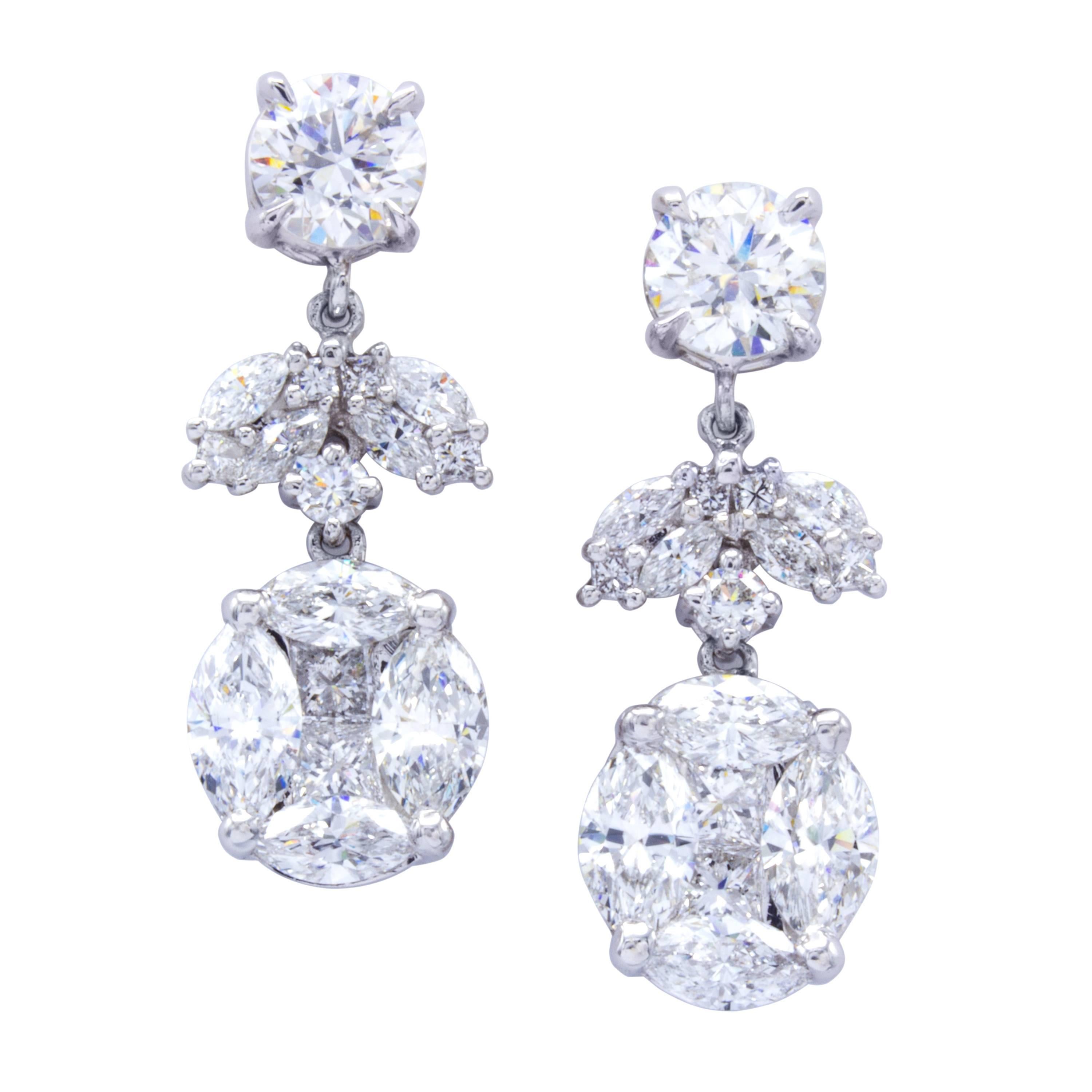 A scintillating design that gathers beautiful GIA certified diamonds in classic shapes and innovates them into an illusion setting. Two round brilliant studs suspend a collection of marquise cut, round brilliant, and princess cut diamonds in 18Kt