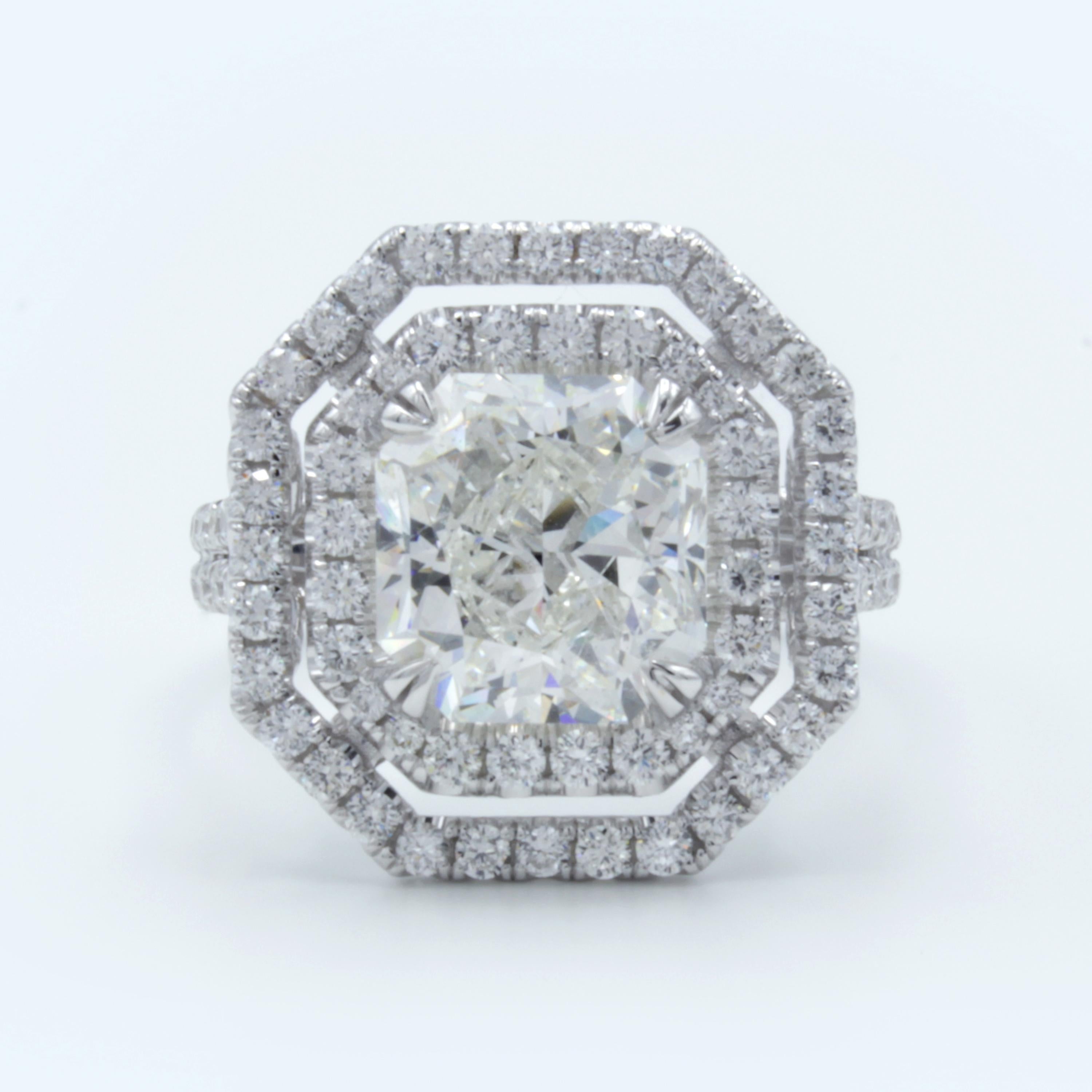 A remarkable Rosenberg Diamonds & Co. engagement ring featuring a GIA certified 3.51 carat radiant cut diamond within a band of 18Kt white gold. The setting shows a beautiful double halo split shank design glittering with round brilliant pave set