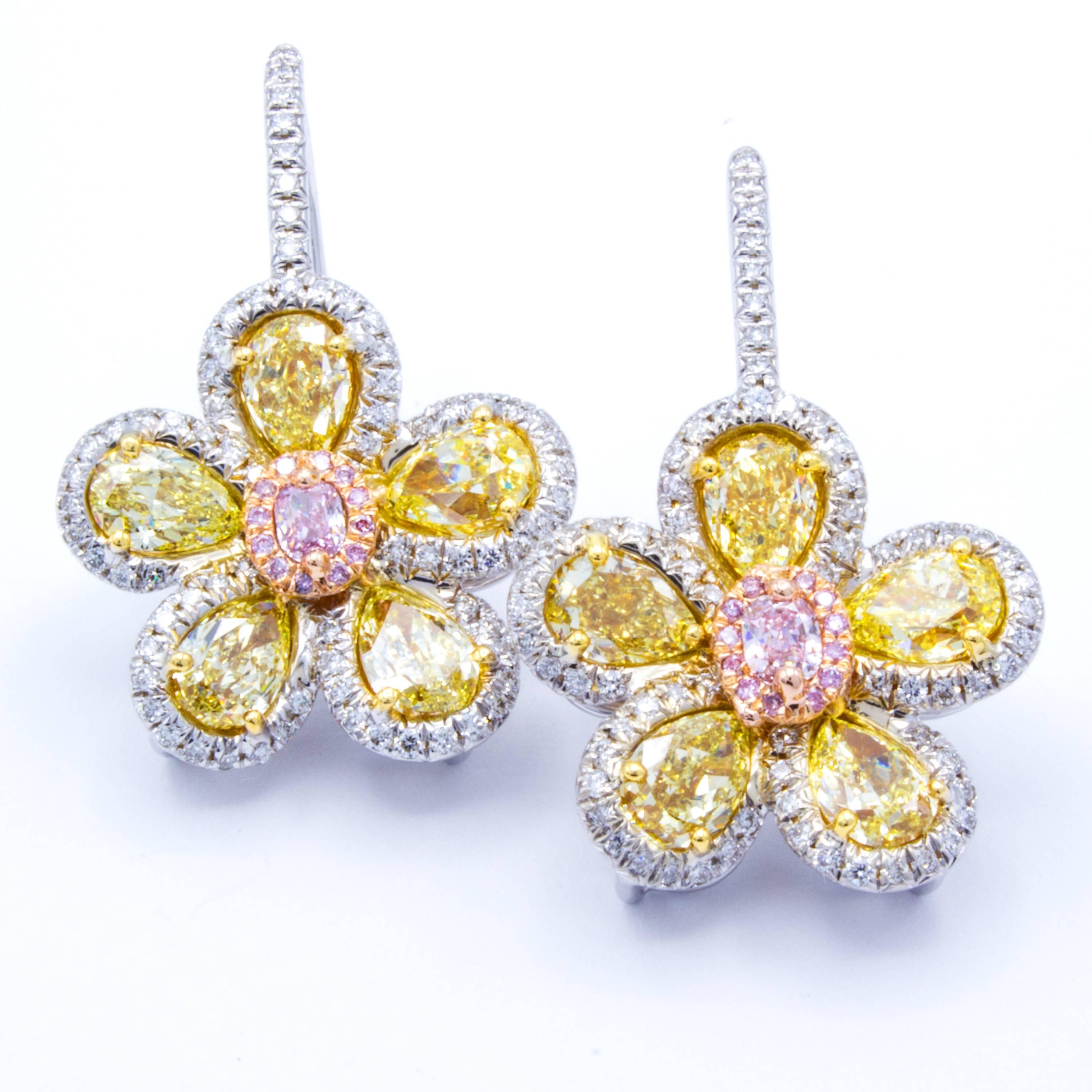 Elegant floral motifs shine in these beautiful 18kt multicolor gold and diamond drop earrings from Rosenberg Diamonds & Co. Glistening petals of pave set round brilliant white diamonds accent natural fancy colored yellow pear shape diamonds in 18kt