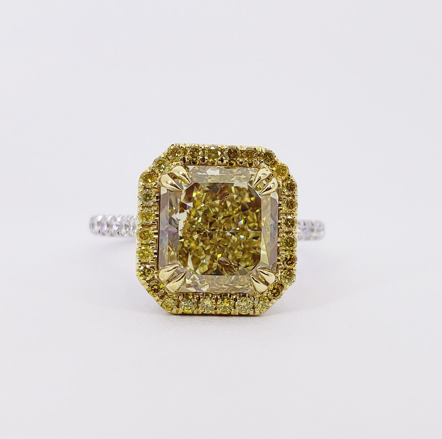Rosenberg Diamonds & Co. 4.03 carat Radiant cut Fancy Intense Yellow VS2 clarity is accompanied by a GIA certificate. This striking Radiant is full of brilliance and it is set in a handmade 18 karat white & yellow gold setting. This ring completes