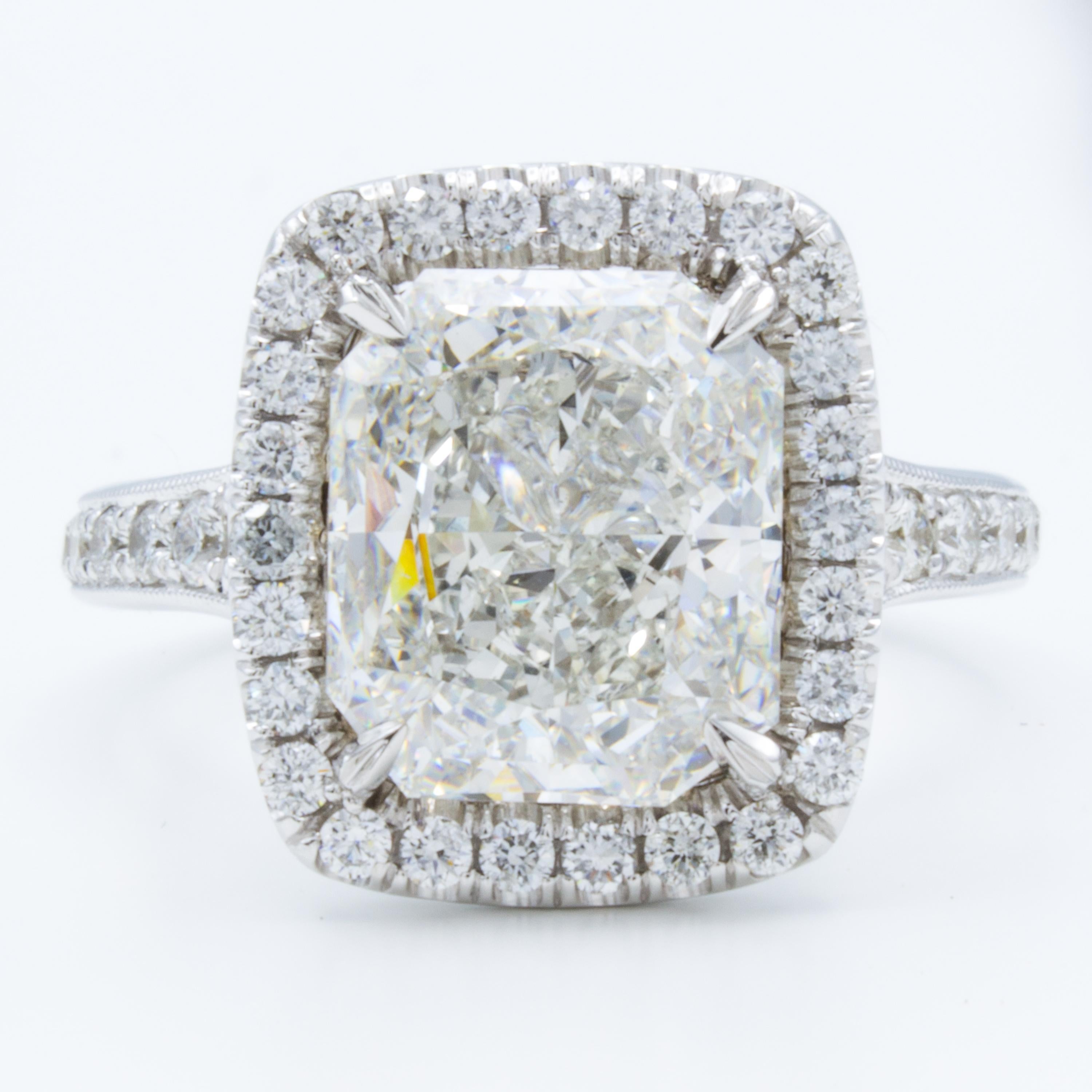 This Rosenberg Diamonds & Co. engagement ring displays a brilliant GIA certified 4.04 carat radiant cut diamond embraced by round brilliant pave diamond accents. The 18kt white gold setting shines with further round brilliant diamond accents and a