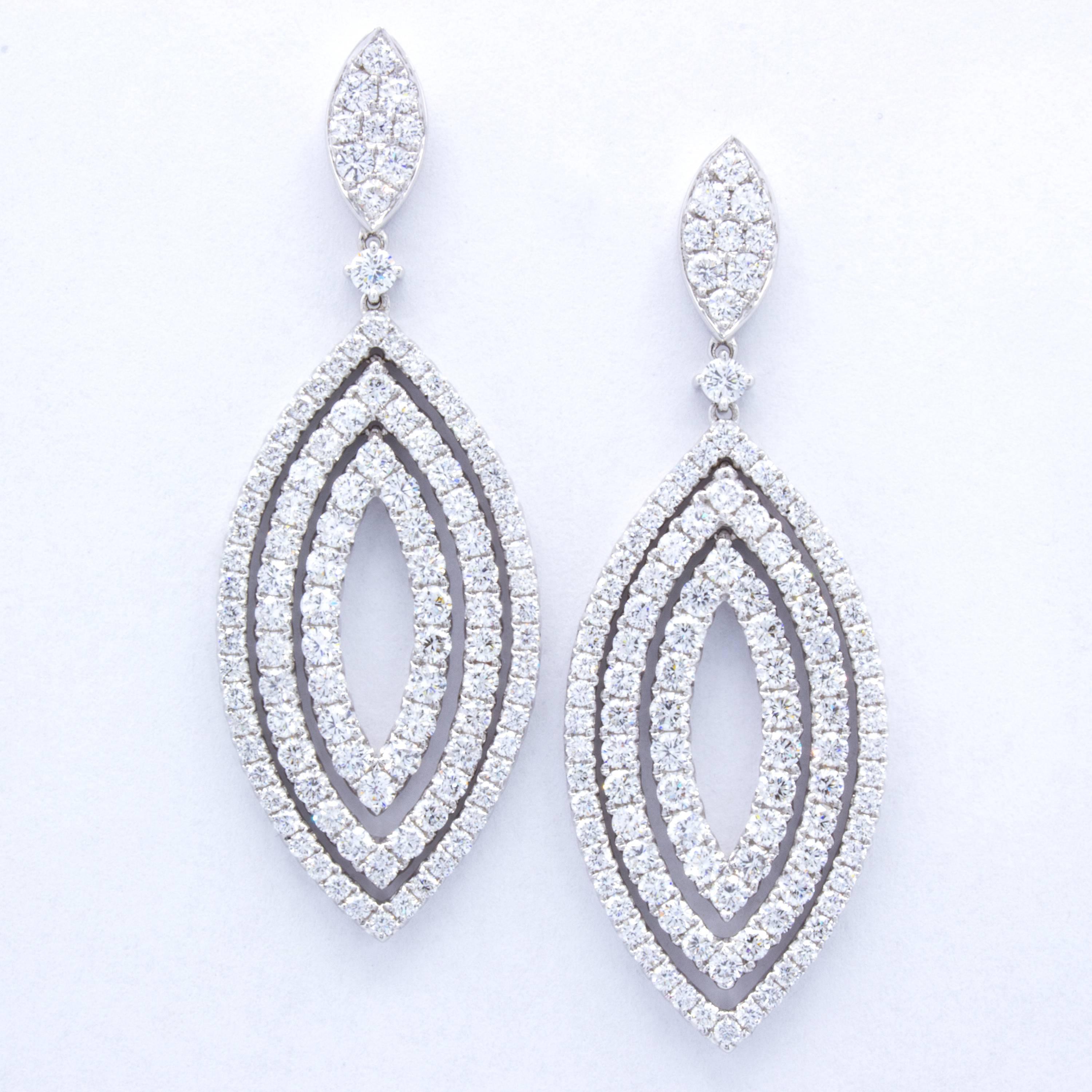 A contemporary classic in the form of 18Kt white gold and brilliant round diamonds. These Rosenberg Diamonds & Co. diamond dangle earrings show three concentric marquise motifs, accented with glittering pave set stones. Designed by David Rosenberg.