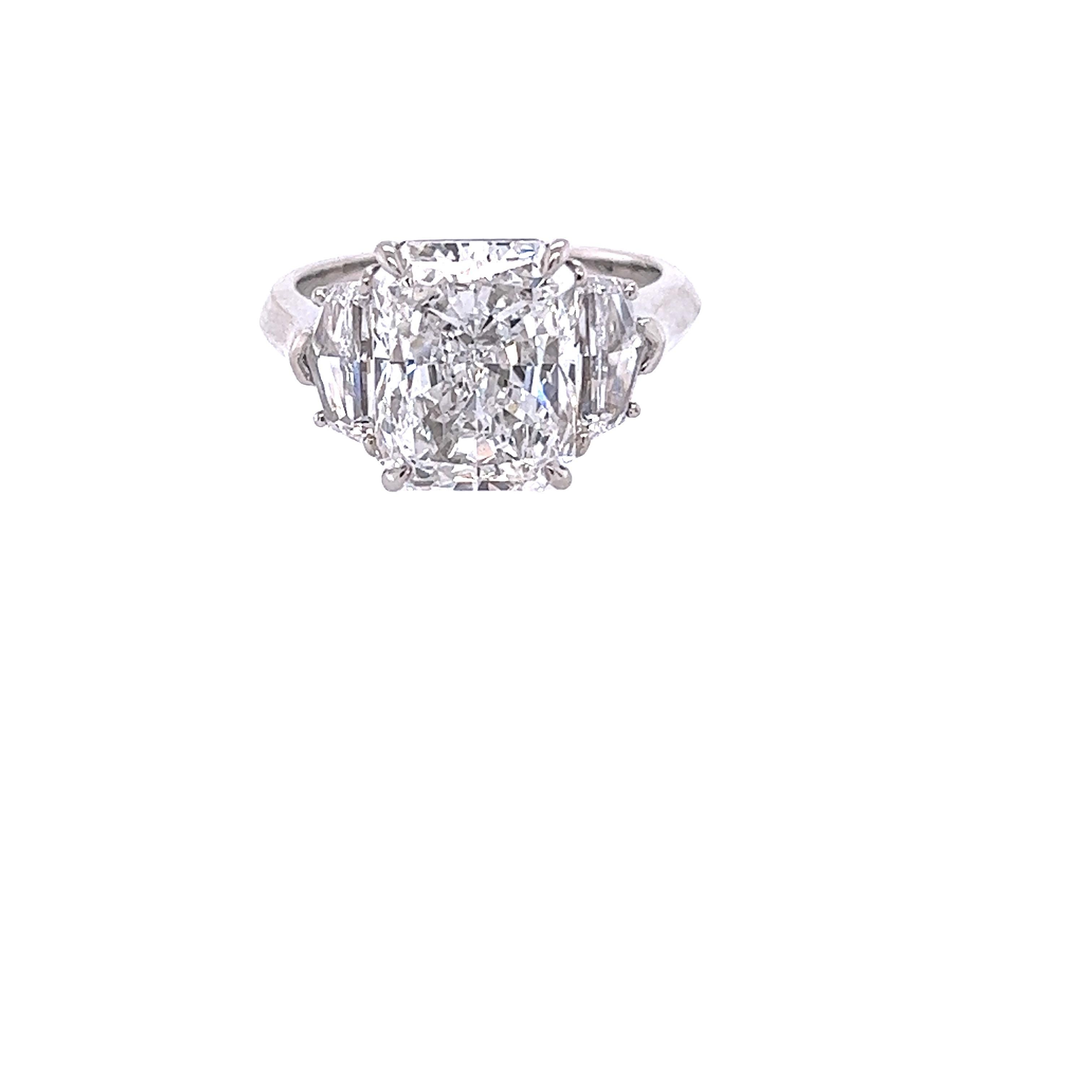 Rosenberg Diamonds & Co. 5.01 carat Emerald cut F color SI1 clarity is accompanied by a GIA certificate. This spectacular Radiant is set in a handmade platinum setting with perfectly matched pair of epauletts side stones flanking on both sides with