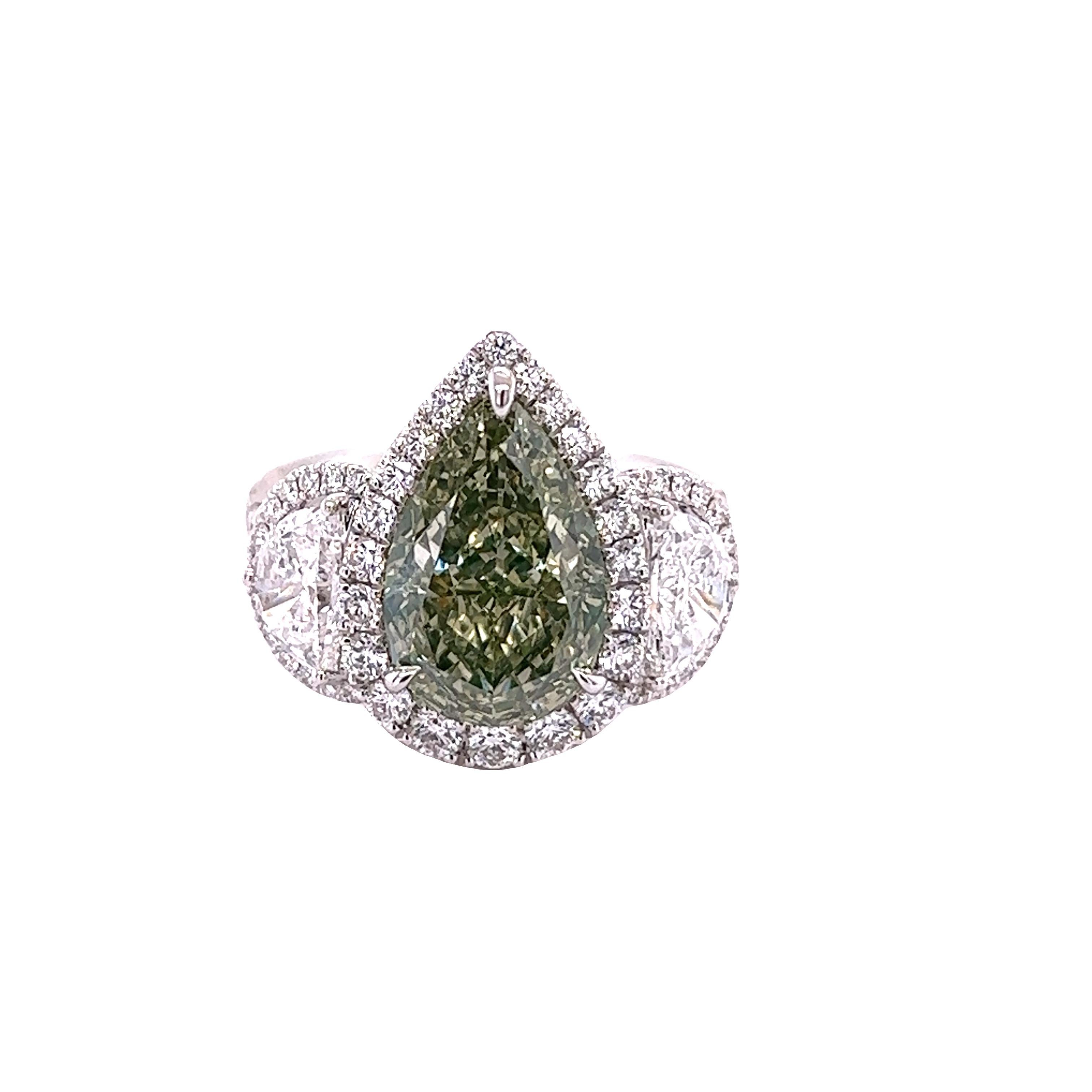 Rosenberg Diamonds & Co. 5.02 carat Pear shape Fancy Green Yellow VS1 clarity is accompanied by a GIA certificate. This spectacular rare pear is full of brilliance and is set in a handmade 18k white gold setting with perfectly matched pair of
