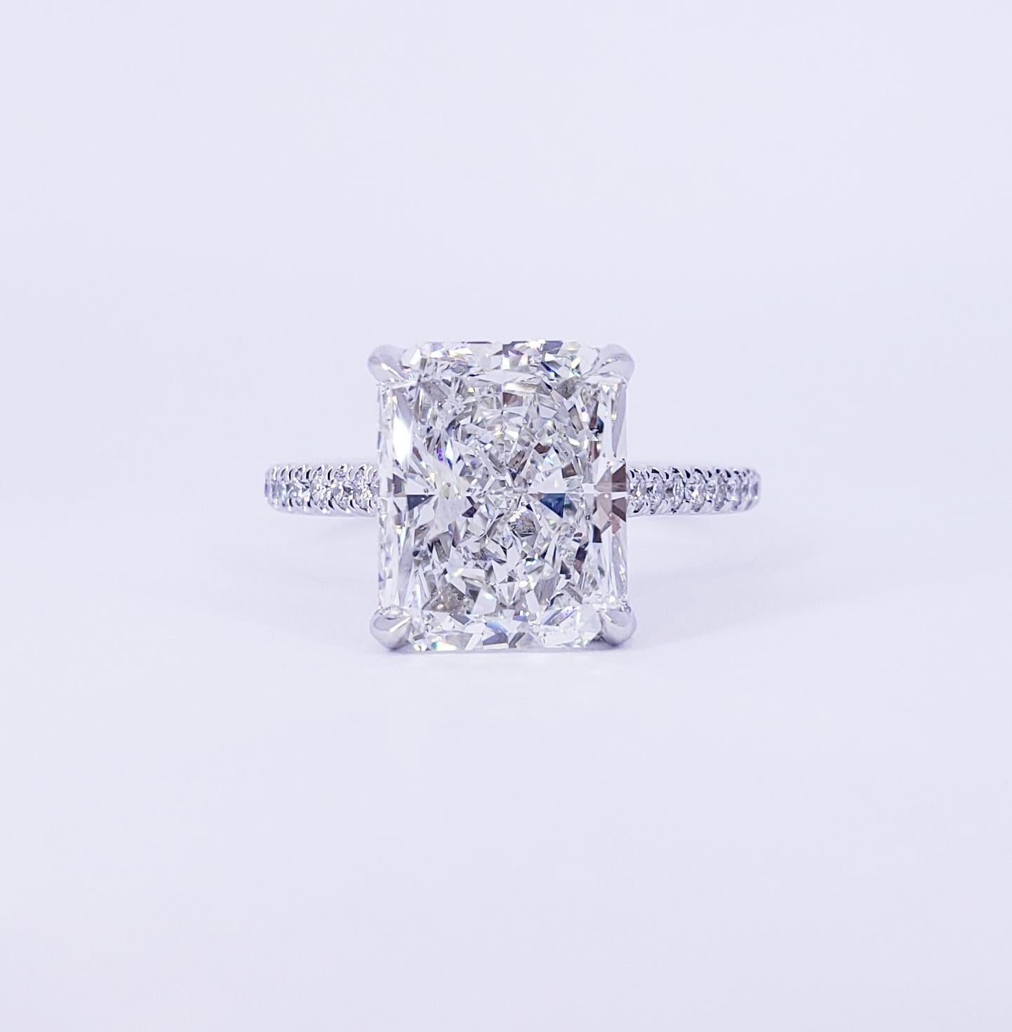 Rosenberg Diamonds & Co. 5.02 carat Radiant cut H color SI1 clarity is accompanied by a GIA certificate. This spectacular elongated Radiant is full of brilliance and it is set in a handmade 18k white gold setting. This ring continues its elegance