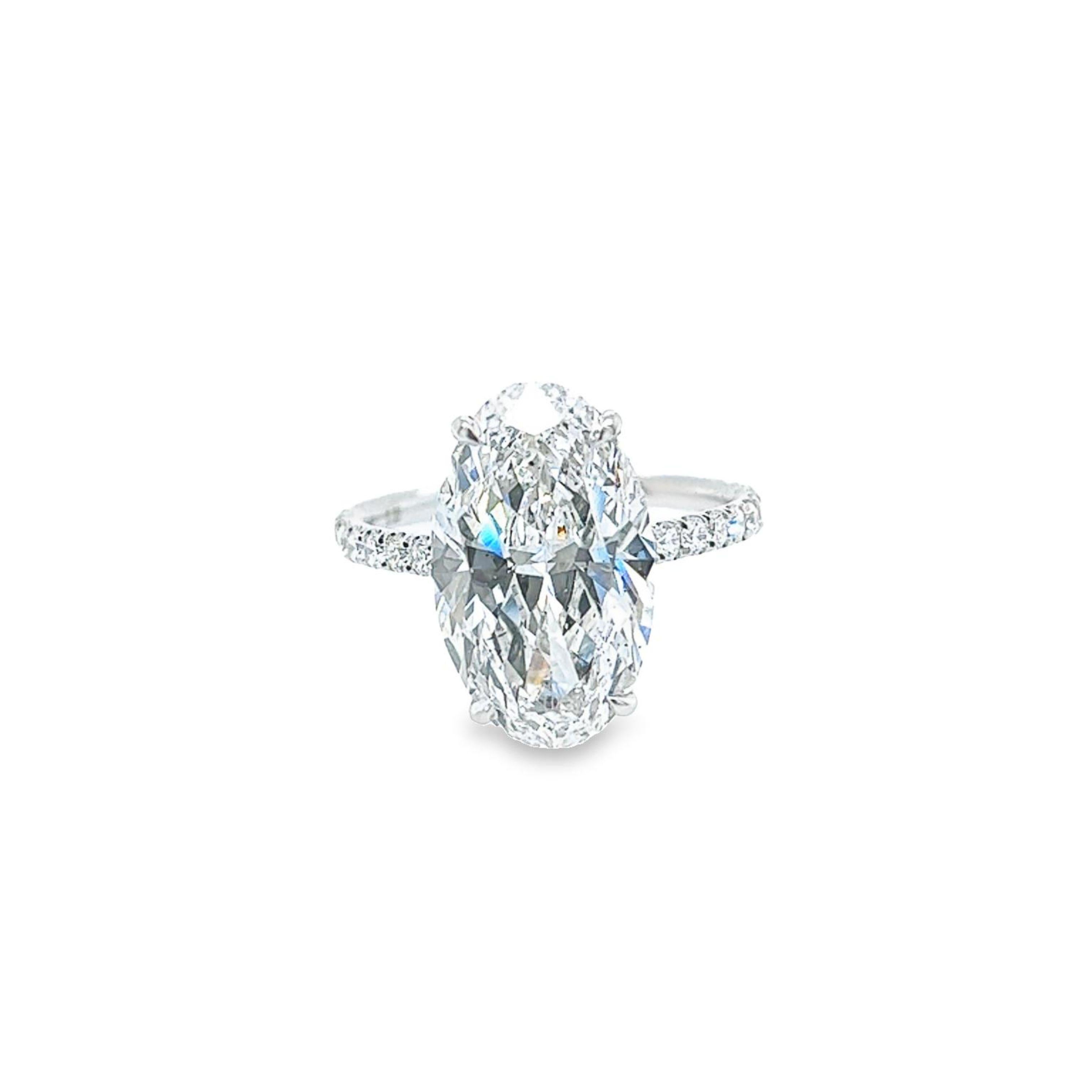 Rosenberg Diamonds & Co. 5.18 carat Oval cut D color SI2 clarity is accompanied by a GIA certificate. This beautiful Oval is full of brilliance and an exceptional SI2 that is set in a handmade platinum setting. This ring continues its elegance with