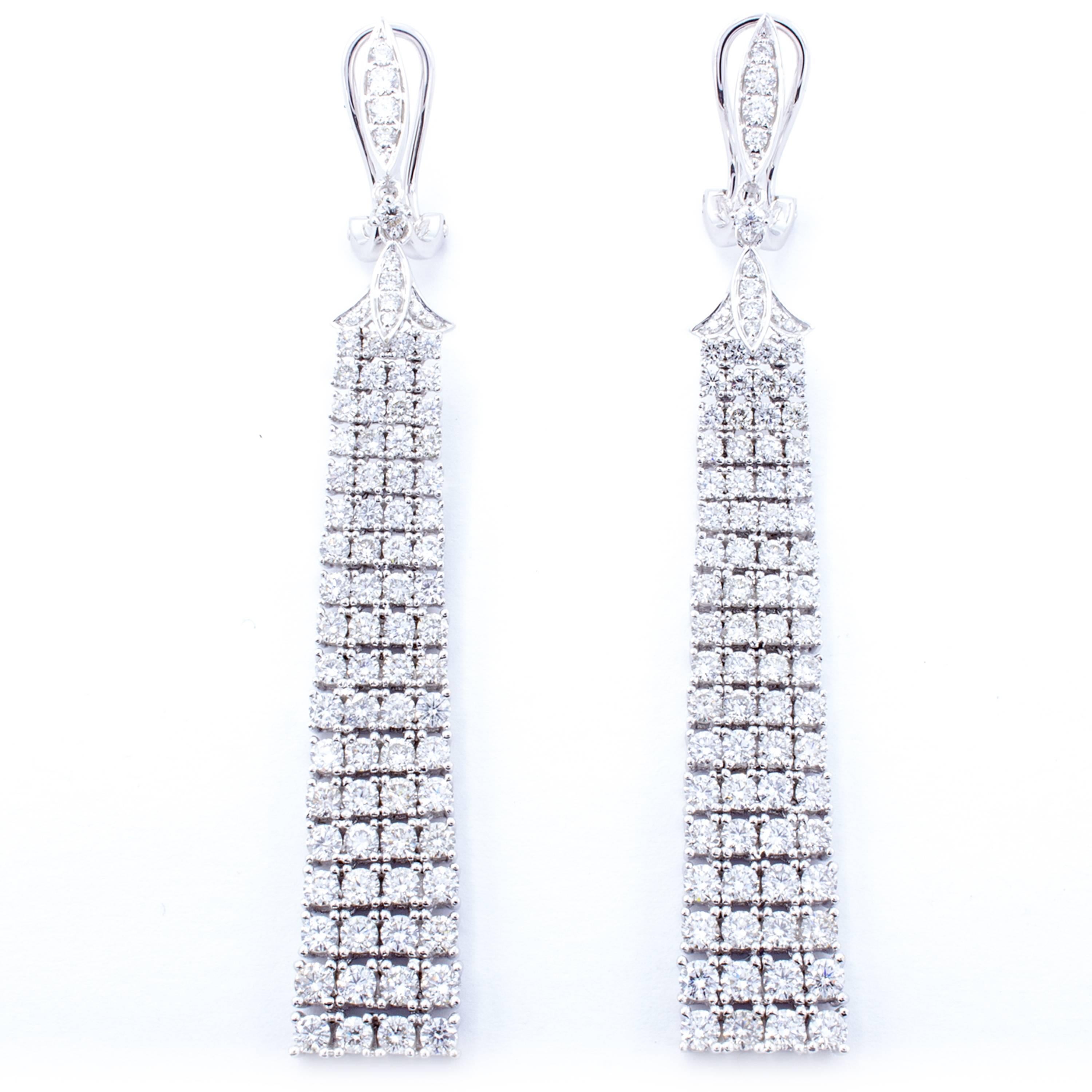 A delightfully deco style adorns these glistening drop dangle earrings. Banners of 18Kt white gold wave with 170 round brilliant diamonds combining for 5.45 total carats of breathtaking scintillation. Designed by David Rosenberg.

Details: