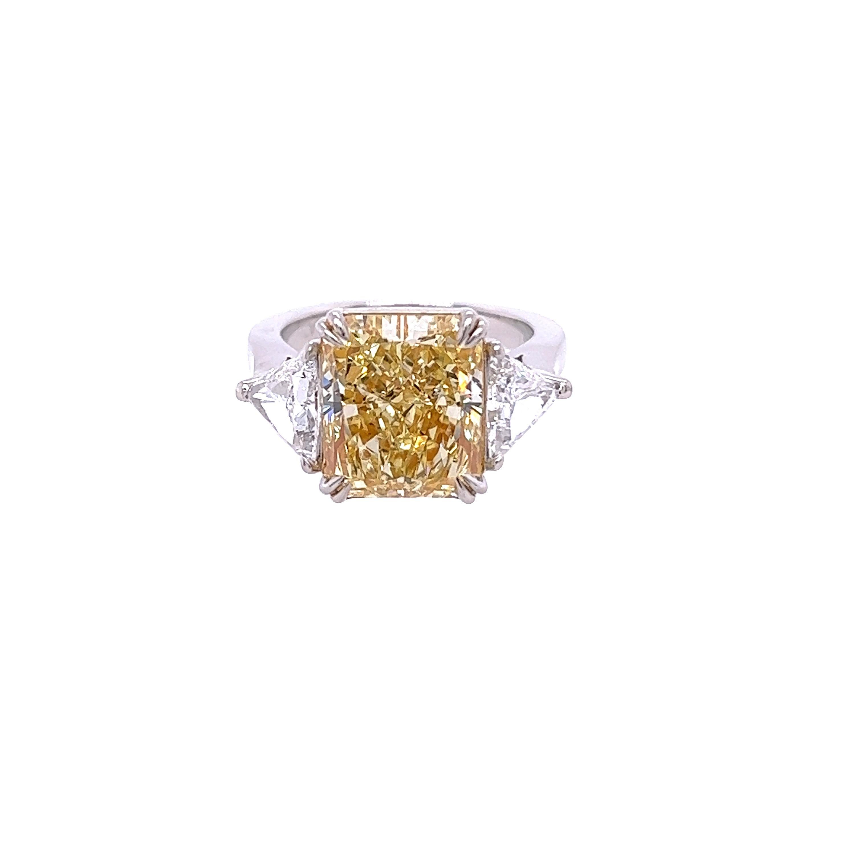 Rosenberg Diamonds & Co. 5.68 carat Radiant cut Fancy Light Yellow VS2 clarity is accompanied by a GIA certificate. This striking Radiant is full of brilliance and it is set in a handmade platinum and 18 karat yellow gold setting. This ring