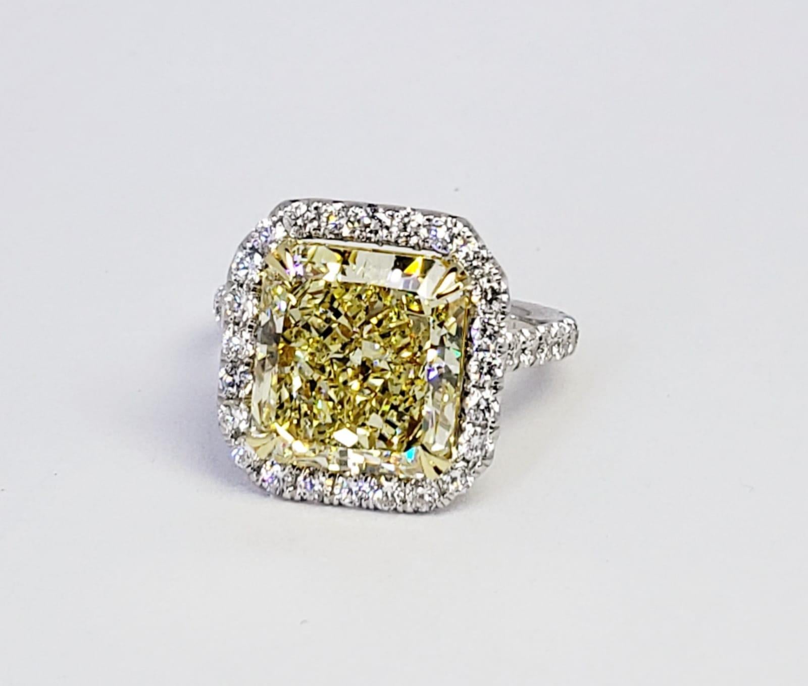 Rosenberg Diamonds & Co. 5.94 carat Radiant cut Fancy Yellow VS2 clarity is accompanied by a GIA certificate. This striking Radiant is full of brilliance and it is set in a handmade platinum and 18 karat yellow gold setting. This ring completes its
