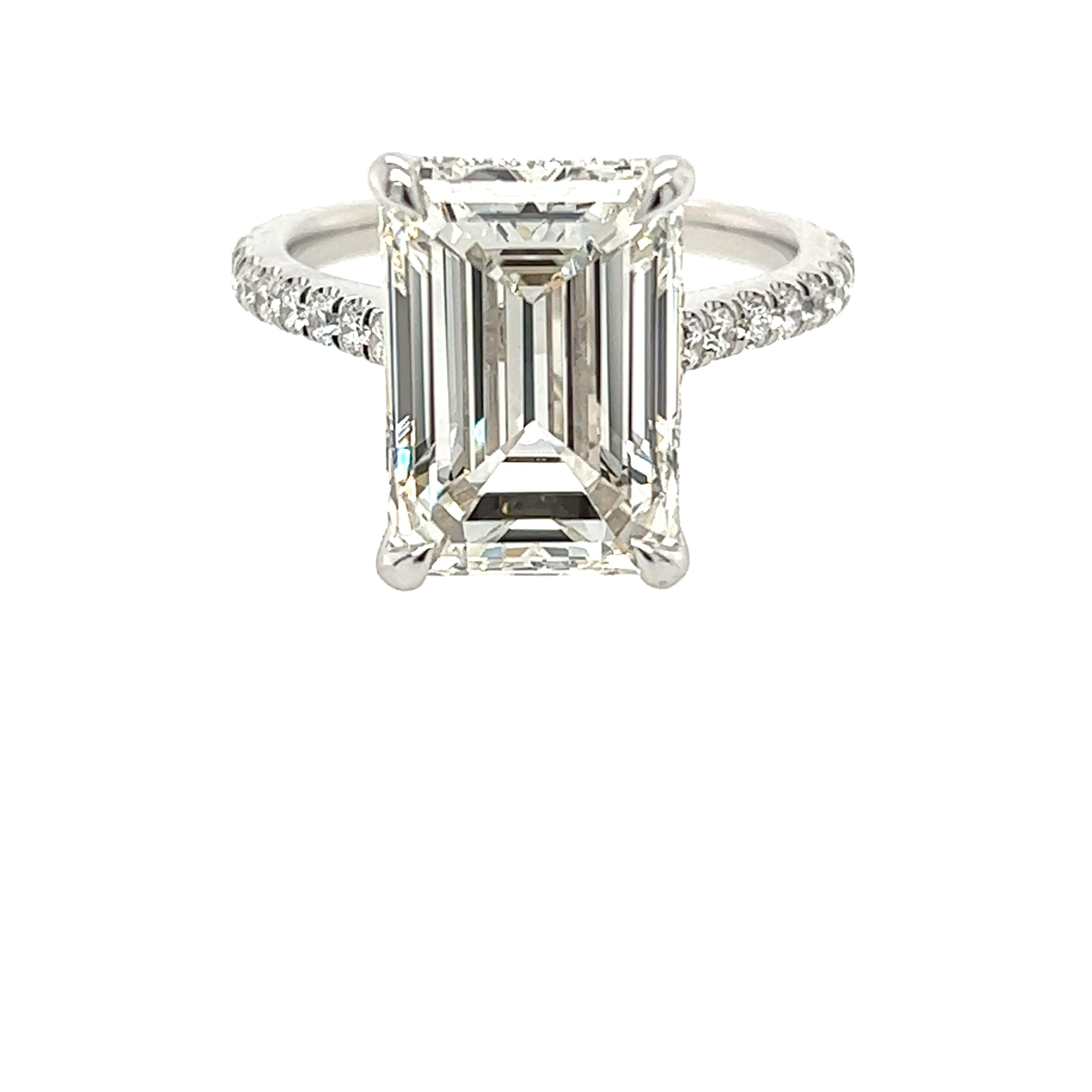 Rosenberg Diamonds & Co. 6.02 carat Emerald cut I color VS1 clarity is accompanied by a GIA certificate. This gorgeous Emerald is full of brilliance and it is set in a handmade platinum setting and continues its elegance with a row of micro pave