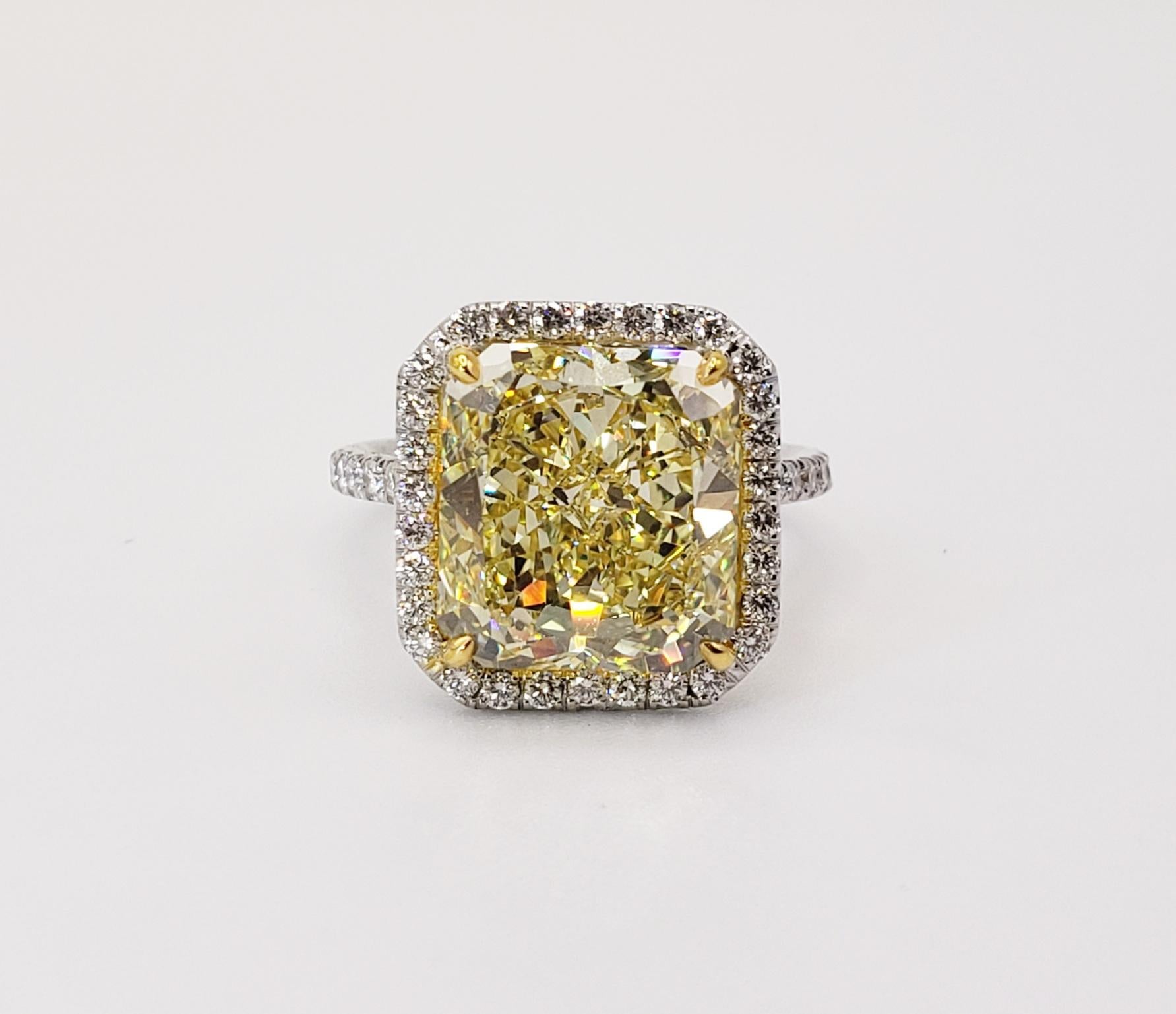 Rosenberg Diamonds & Co. 6.02 carat Radiant cut Fancy Yellow VS2 clarity is accompanied by a GIA certificate. This striking Radiant is full of brilliance and it is set in a handmade 18 karat white and yellow gold setting. This ring completes its