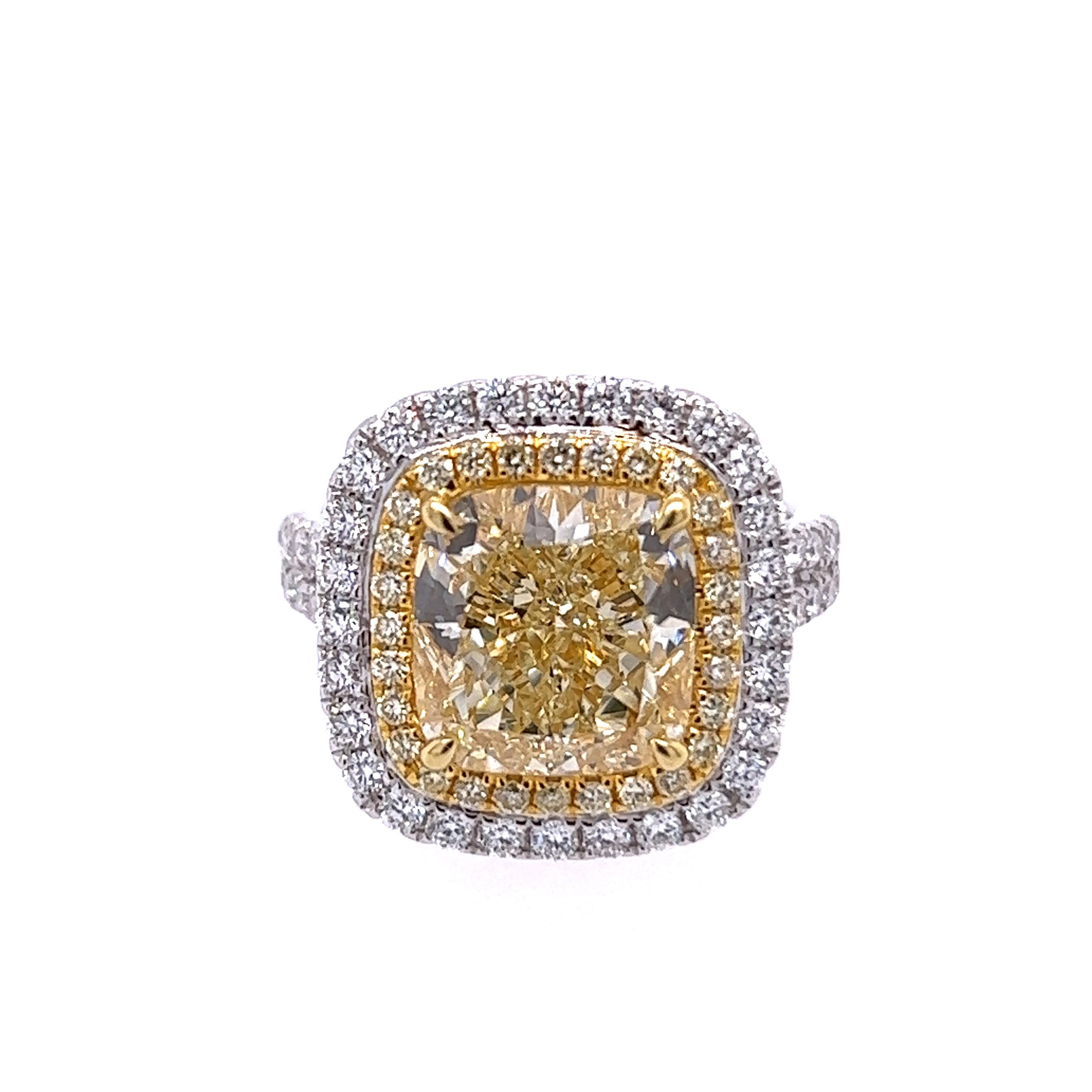 Rosenberg Diamonds & Co. 6.14 carat Cushion cut light yellow VS2 clarity is accompanied by a GIA certificate. This incredible bright cushion is full of life and it is set in a handmade 18 karat white & yellow gold setting. This ring completes its