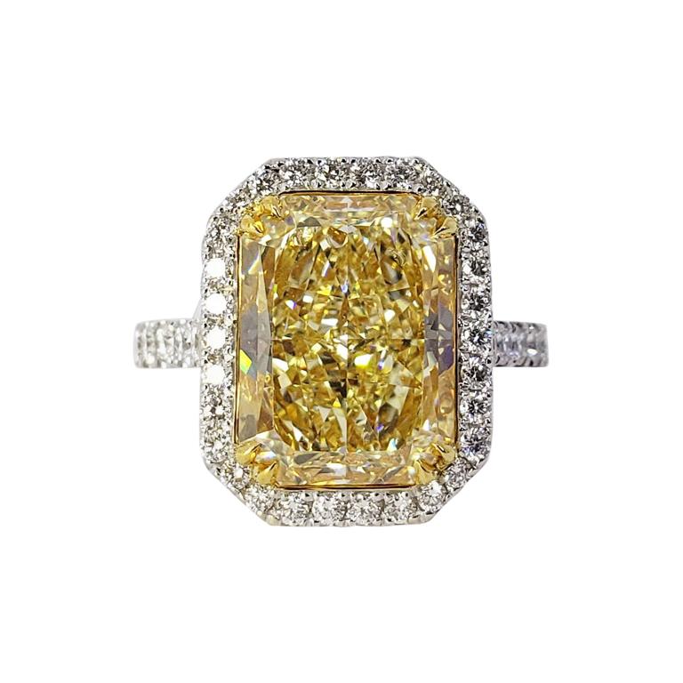 Rosenberg Diamonds & Co. 6.54 carat Radiant Cut Light Yellow VS1 clarity is accompanied by a GIA certificate. This spectacular Radiant is full of brilliance and it is set in a handmade 18 karat white & yellow gold setting. This ring continues its