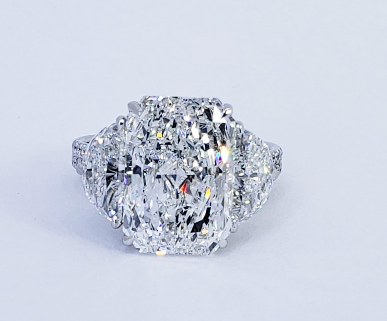 Rosenberg Diamonds & Co. 6.81 carat Radiant cut H color SI1 clarity is accompanied by a GIA certificate. This spectacular elongated Radiant is full of brilliance and it is set in a handmade platinum setting with perfectly matched pair of brilliant