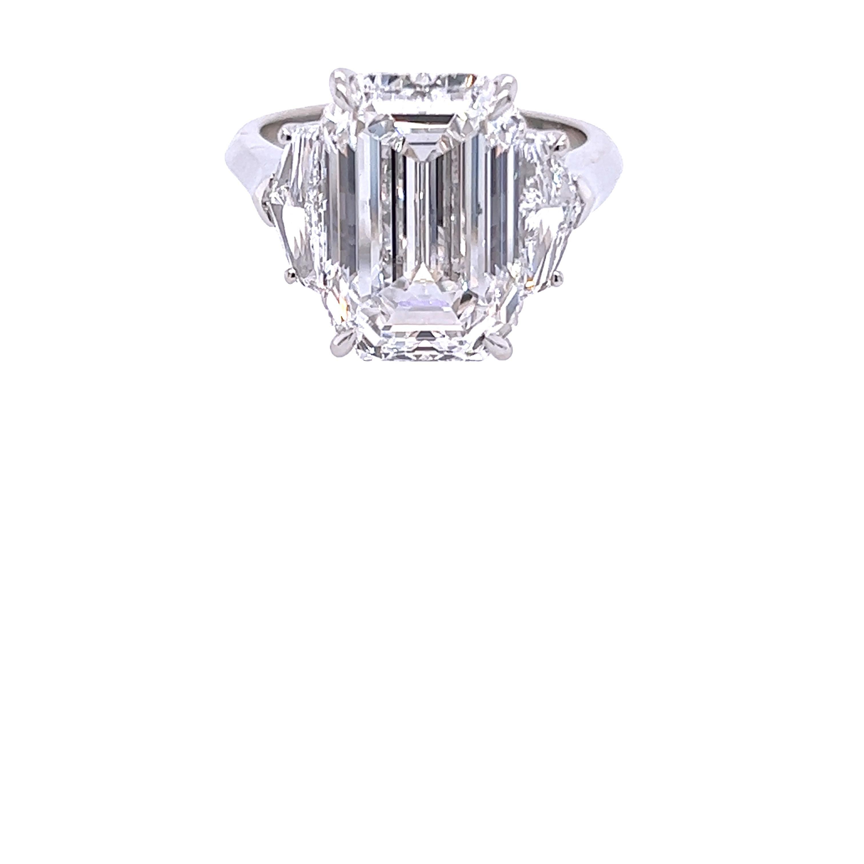 Rosenberg Diamonds & Co. 7.03 carat Emerald cut D color VS2 clarity is accompanied by a GIA certificate. This spectacular Emerald is set in a handmade platinum setting with perfectly matched pair of Epaulette side stones flanking on both sides with