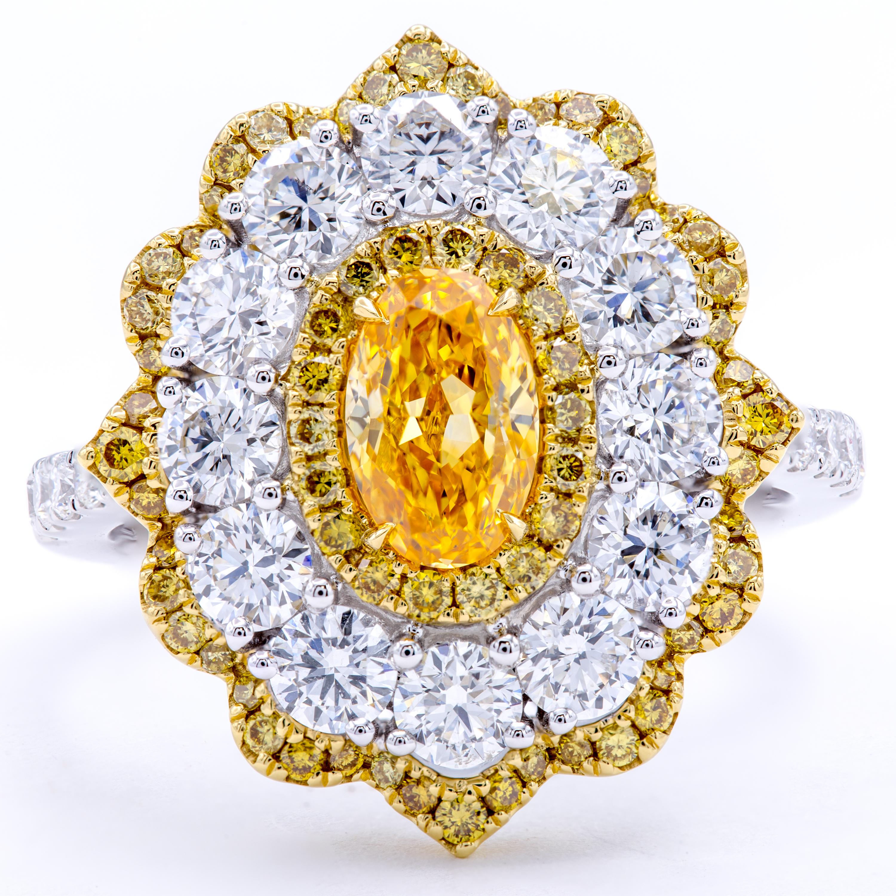 An elegant design exploding with succulent color. This diamond engagement ring shows a bright floral design with petals of natural fancy yellow and white round brilliant diamonds accenting the incredibly colorful GIA certified natural fancy intense