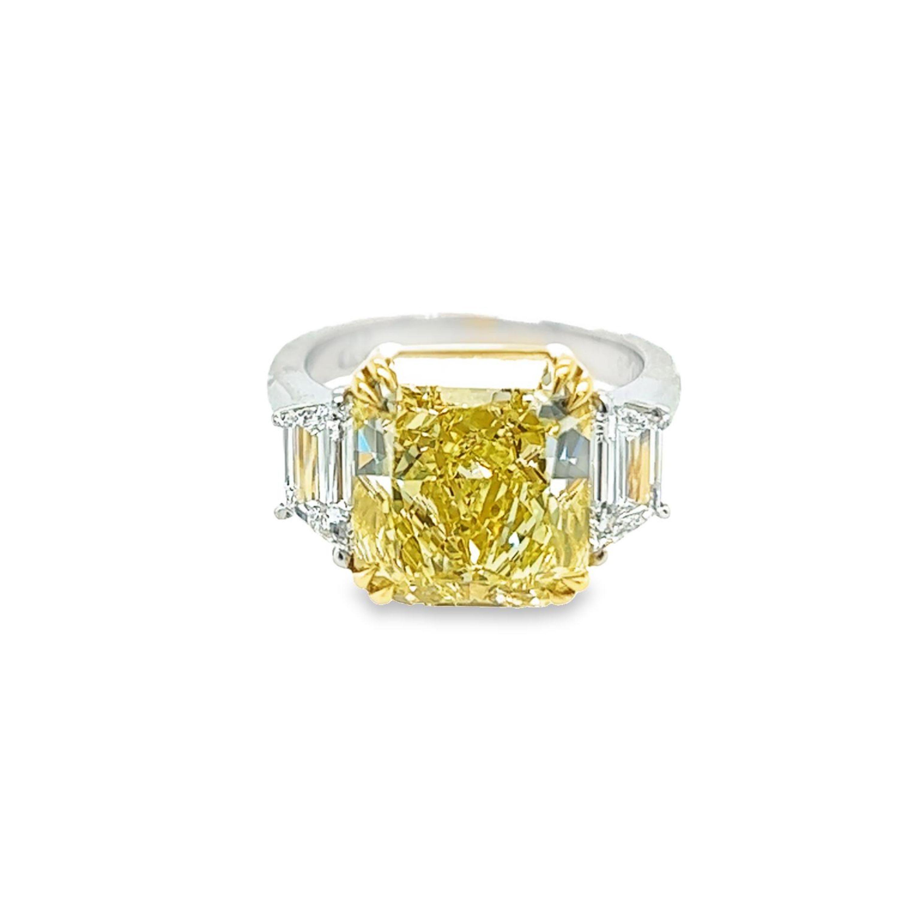 Rosenberg Diamonds & Co. 7.81 carat Radiant Cut Fancy Yellow VVS2 clarity is accompanied by a GIA certificate. This beautiful bright radiant cut is set in a handmade platinum & 18k yellow gold setting with perfectly matched pair of trapezoid side
