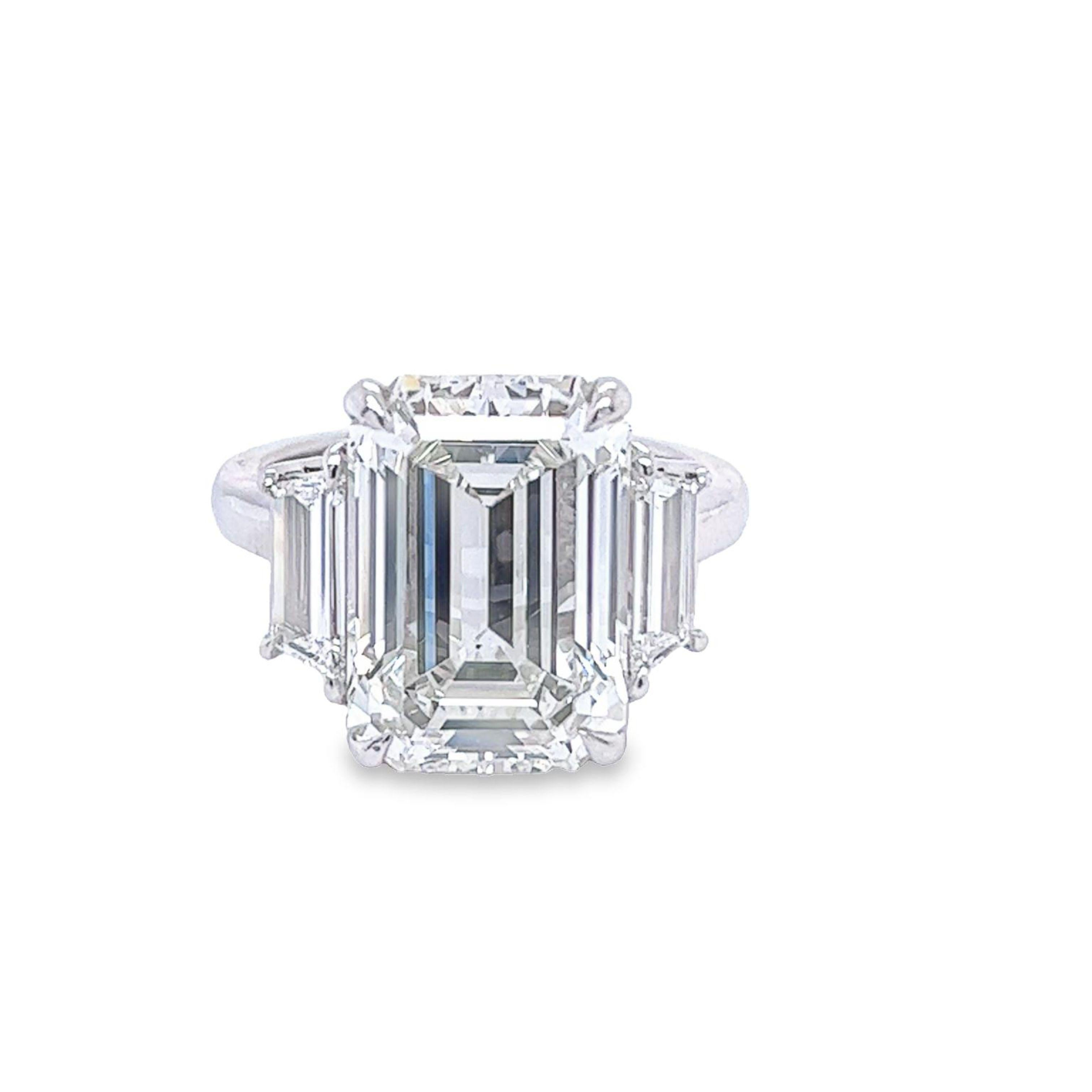 Rosenberg Diamonds & Co. 8.37 carat Emerald cut I color VS1 clarity is accompanied by a GIA certificate. This gorgeous Emerald is set in a handmade platinum setting with perfectly matched pair of step cut side stones flanking on both sides with a