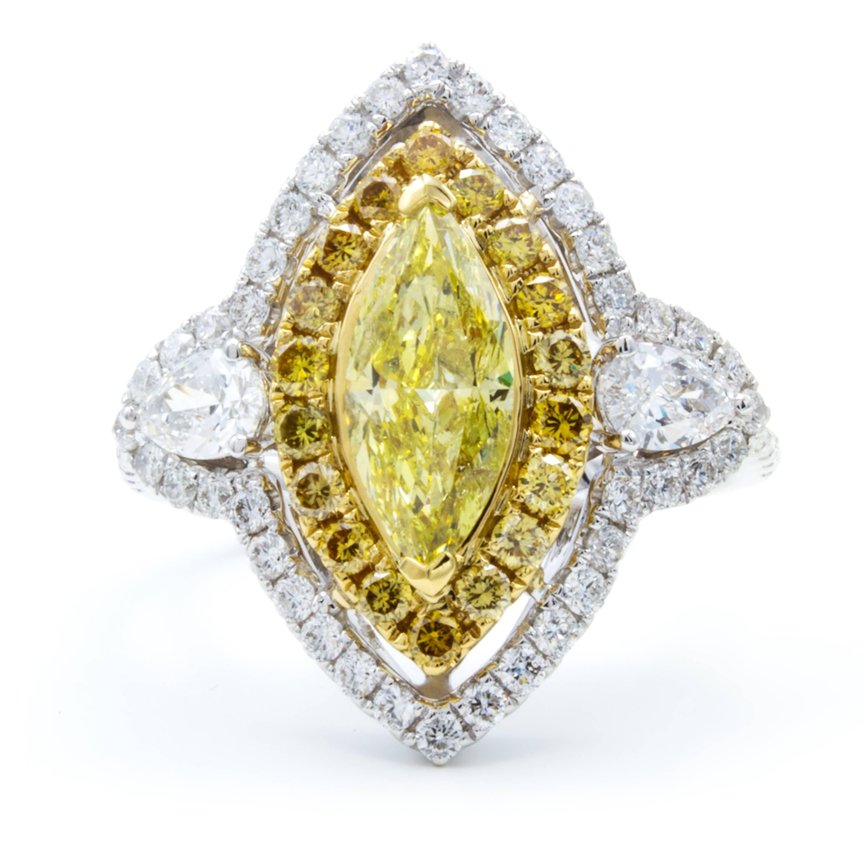 The rare and elegant marquise cut is celebrated in this Rosenberg Diamonds & Co. engagement ring featuring a GIA certified .93 carat marquise diamond. The center stone boasts an incredibly rich natural fancy intense yellow color within an elegant