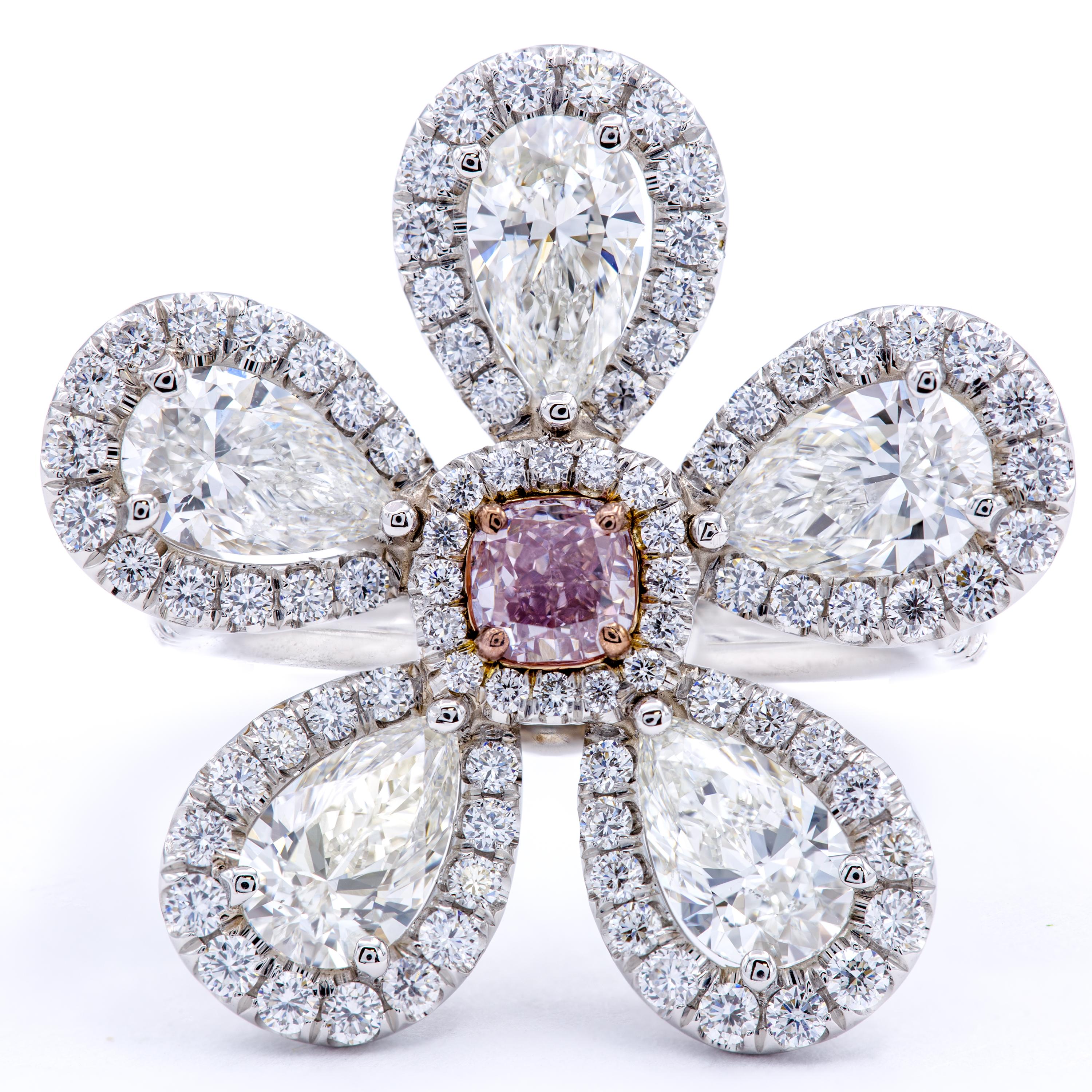 A brilliant bouquet of hand selected diamonds carries a beautiful display of pear shaped diamond petals and a GIA certified natural fancy purplish pink center stone. The band combines pure platinum with 18Kt rose gold and sets over a carat of