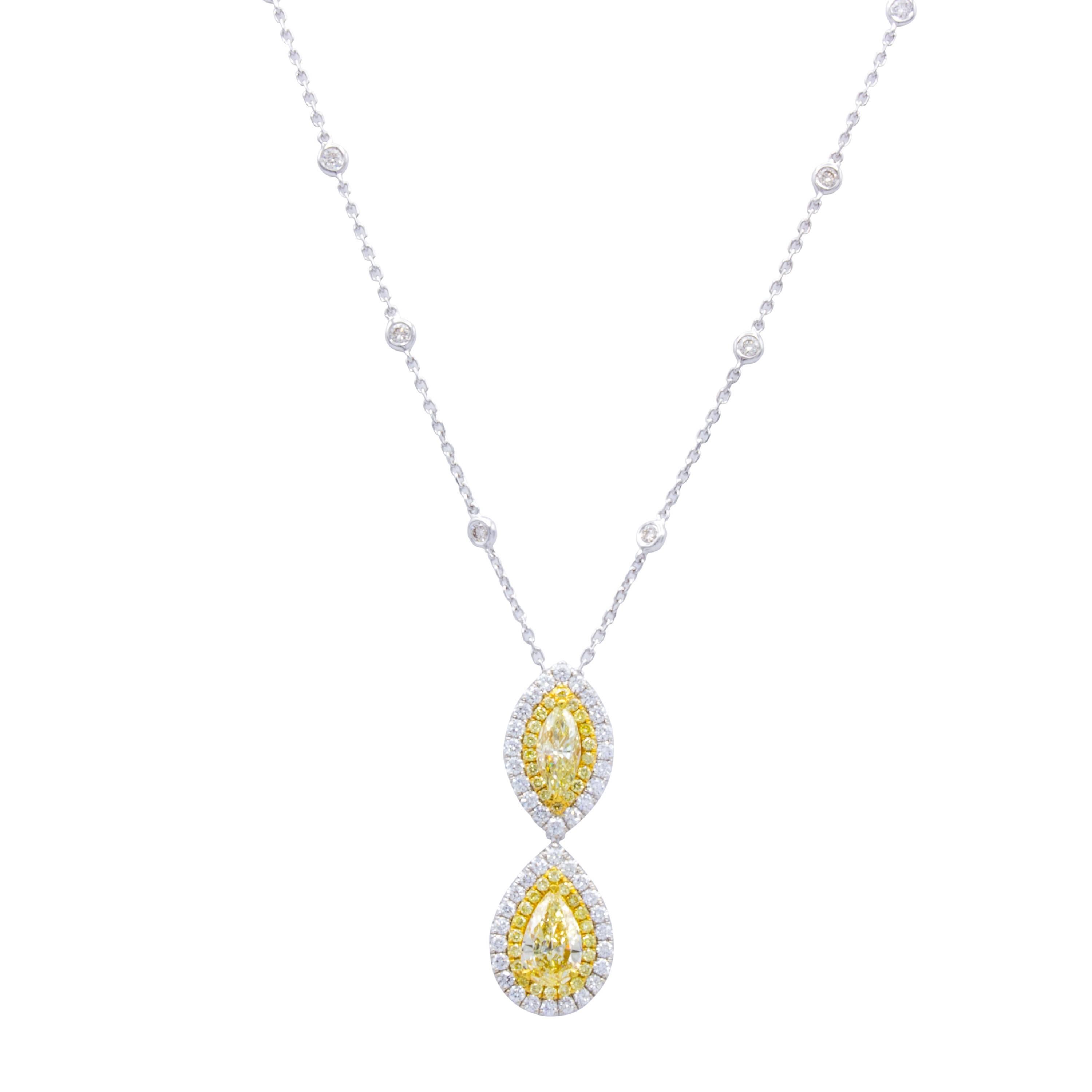 A Rosenberg Diamonds & Co. pendant necklace featuring two incredibly rare and beautiful natural fancy yellow marquise diamonds. Two rows of round brilliant pave diamonds in white and yellow surround the stones and dangle from a delicate 18Kt white