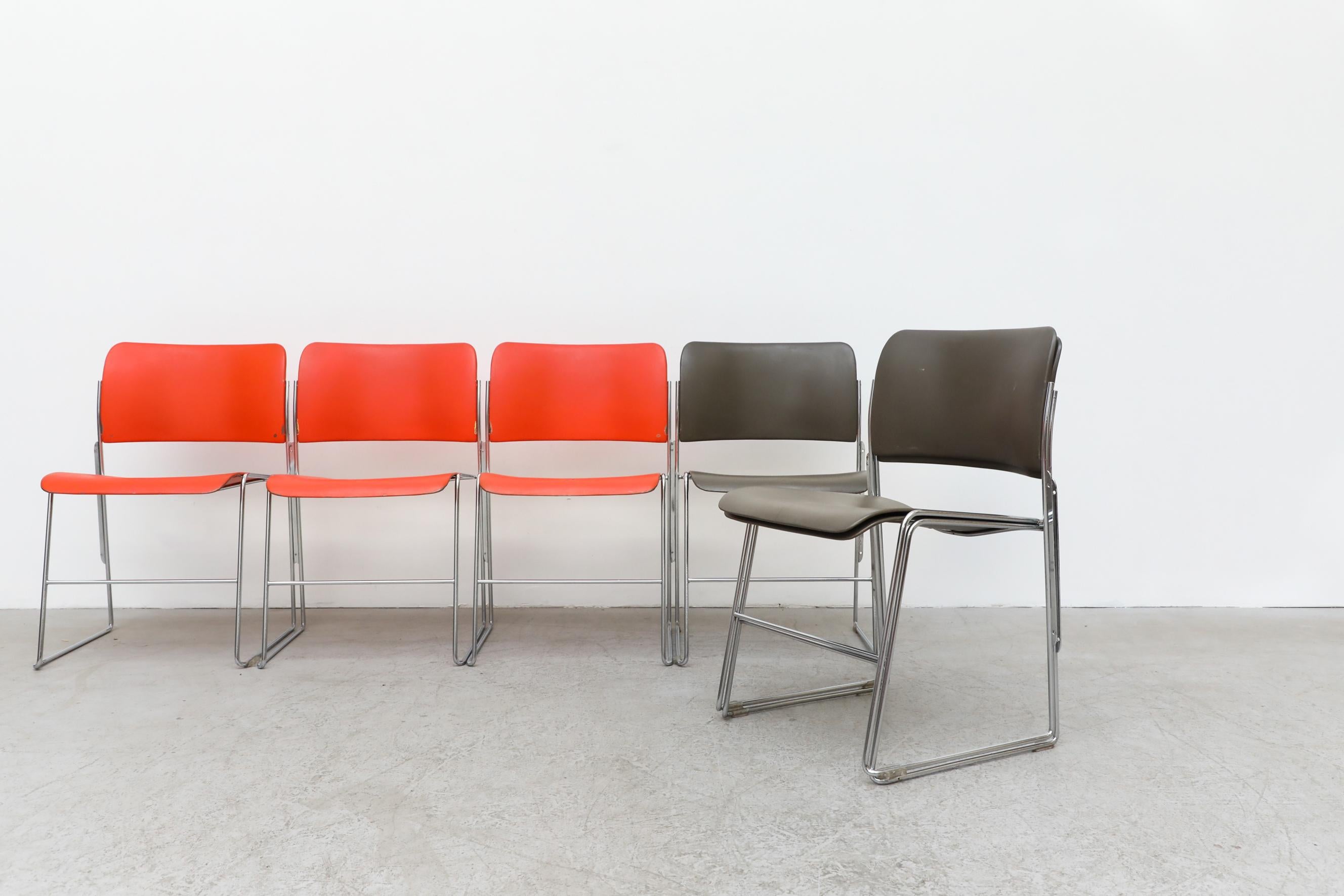 The 40/4 metal stacking chairs designed by David Rowland for The General Fireproofing Co, 1974. Award wining chair design, featured in multiple museums. Available in orange and grey. In original condition with visible wear, consistent with their age